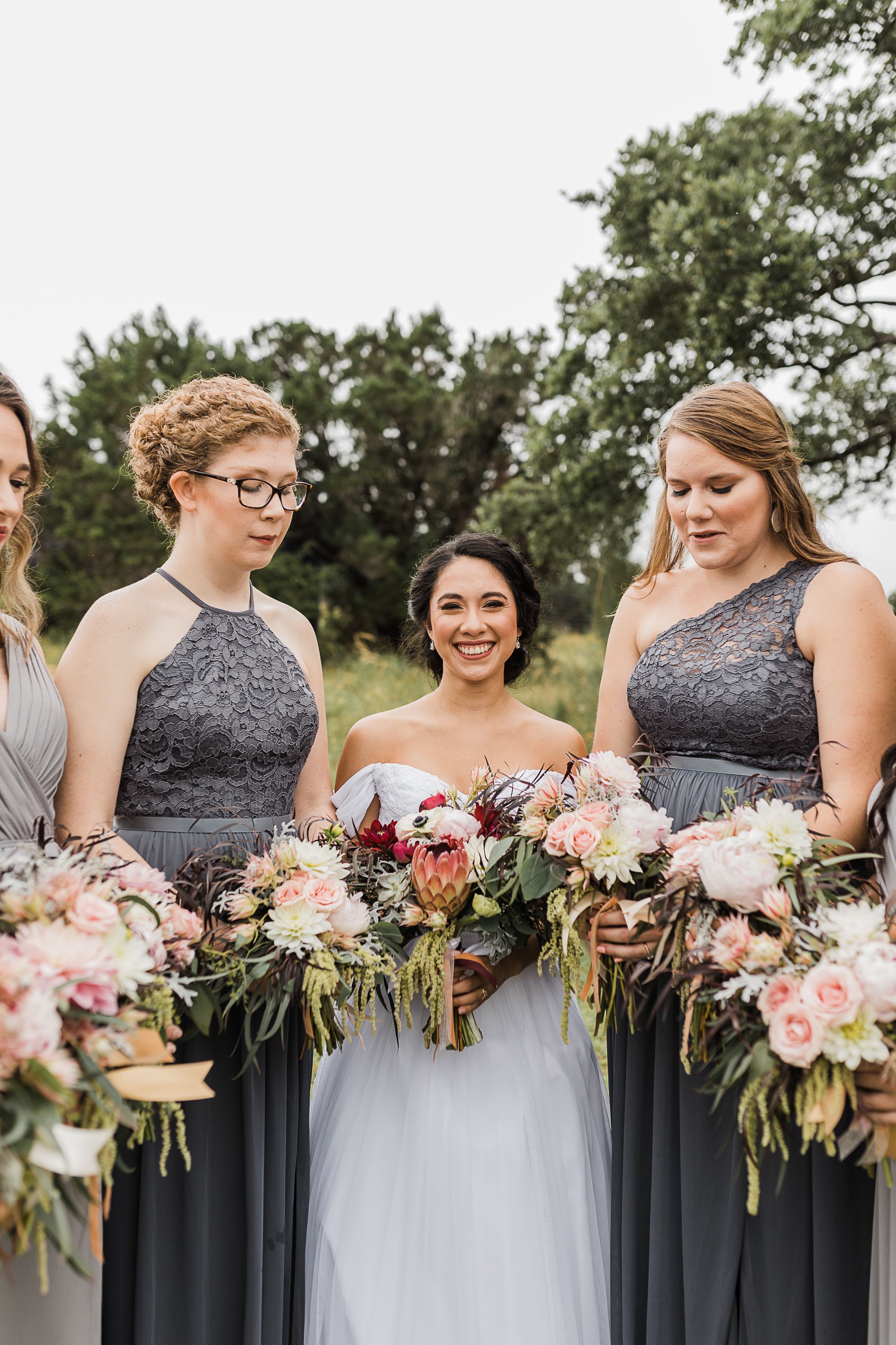Signature Bridesmaid Bouquet - Designed to perfectly complement the bridal aesthetic while maintaining its own distinct charm, our Signature Bridesmaid Bouquet offers a refined, cohesive look for your wedding party. This custom-crafted arrangement is a smaller, more streamlined version of the bridal bouquet, ensuring a balanced visual flow for your ceremony photos.  Each piece is hand-tied with an emphasis on texture and movement, creating a "garden-fresh" feel that is both elegant and easy to carry.  Design &amp; Details Cohesive Artistry: Tailored to mirror the bridal palette using a curated selection of premium focal blooms and seasonal accents.  Proportional Elegance: Expertly sized to be lightweight and comfortable, allowing your bridesmaids to carry them with ease throughout the day.  Luxury Finishes: Stems are professionally wrapped in high-quality ribbon or silk to match your wedding’s color scheme and fabric textures.  Pristine Quality: We use professional hydration techniques so that every bouquet remains vibrant from the bridal party portraits to the reception centerpieces.  Versatile After the Aisle These bouquets are designed with dual-purpose in mind. Once the ceremony concludes, they serve as the perfect "instant" decor for your reception—simply place them into pre-set vases on the head table or cake table to extend their beauty through the night.