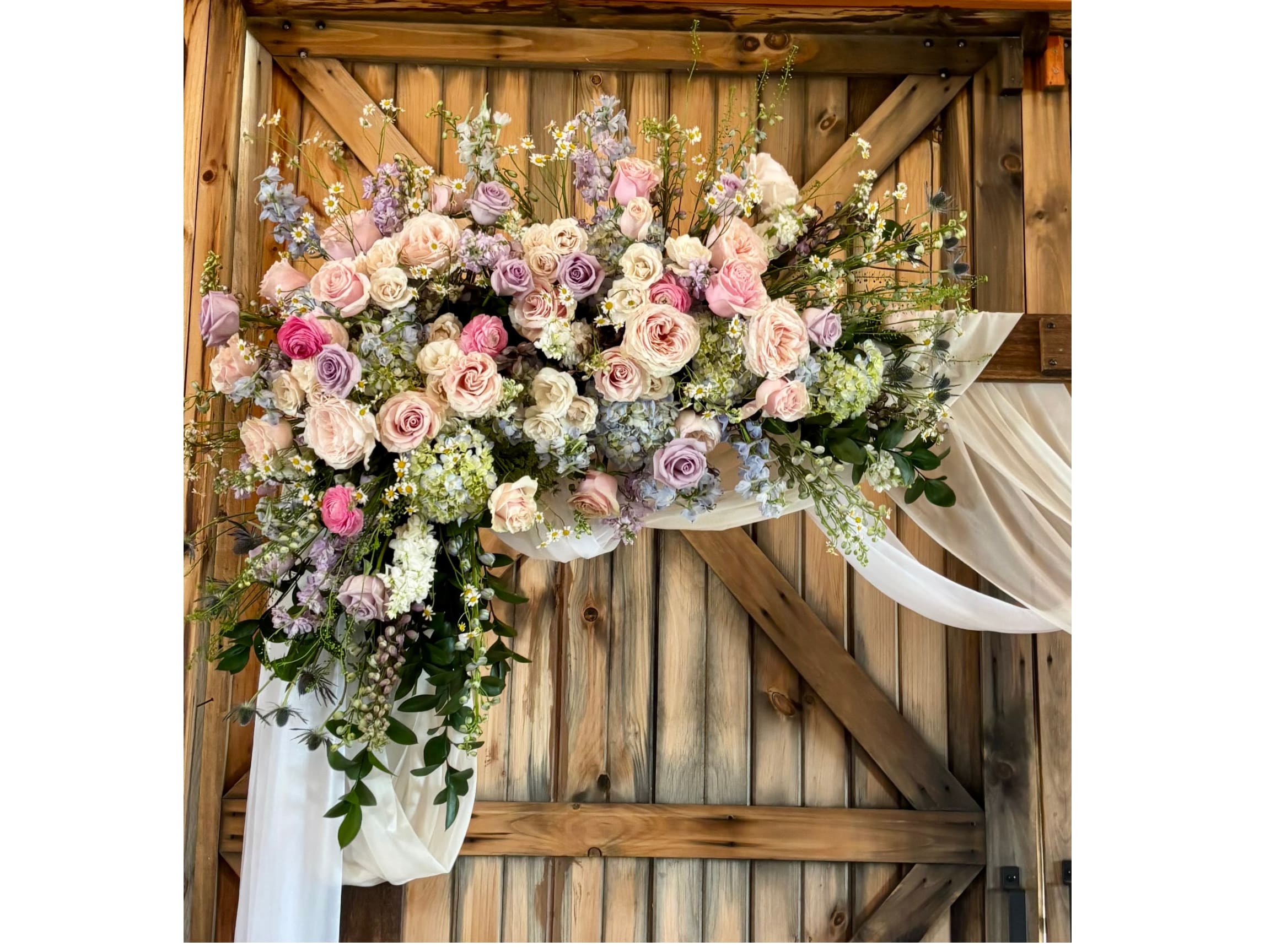 Signature Ceremony Arch  - The Signature Ceremony Arch Frame your "I do" moment with a breathtaking Signature Ceremony Arch. As the focal point of your ceremony, our custom-designed floral arches create a stunning, romantic backdrop that reflects your personal style and elevates your wedding photography. From minimalist greenery to lush, overflowing blooms, we offer three distinct design tiers.  Tier 1: The Elegant Accent Arch Design: Asymmetrical "corner" placements or delicate floral clusters.  Style: Focuses on key focal points of the arch, leaving portions of the structure (wood, gold, or copper) exposed for a modern, airy feel.  Starting at: $450 – $750  Tier 2: The Signature Half-Arch Design: A lush, continuous floral spray covering approximately half to two-thirds of the structure.  Style: Features a dense mix of premium roses, hydrangeas, and cascading greenery for a sophisticated, high-end look.  Starting at: $850 – $1,500  Tier 3: The Luxe Full-Floral Installation Design: A "wall of flowers" effect, fully covering the arch in a dense, botanical landscape.  Style: An immersive, editorial-style installation featuring premium garden blooms and dramatic textures for maximum impact.  Starting at: $2,000+