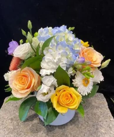 Sweeter than Sugar  - This 'sweet' bouquet in a pure white ceramic vase is exactly that, 'sweet'!  The soft colors of blue hydrangea, lavender freesia, peach and yellow premium roses and pink accent flowers remind me of a perfect sunny Spring day in a field of flowers blowing in the breeze.  I hope you agree!