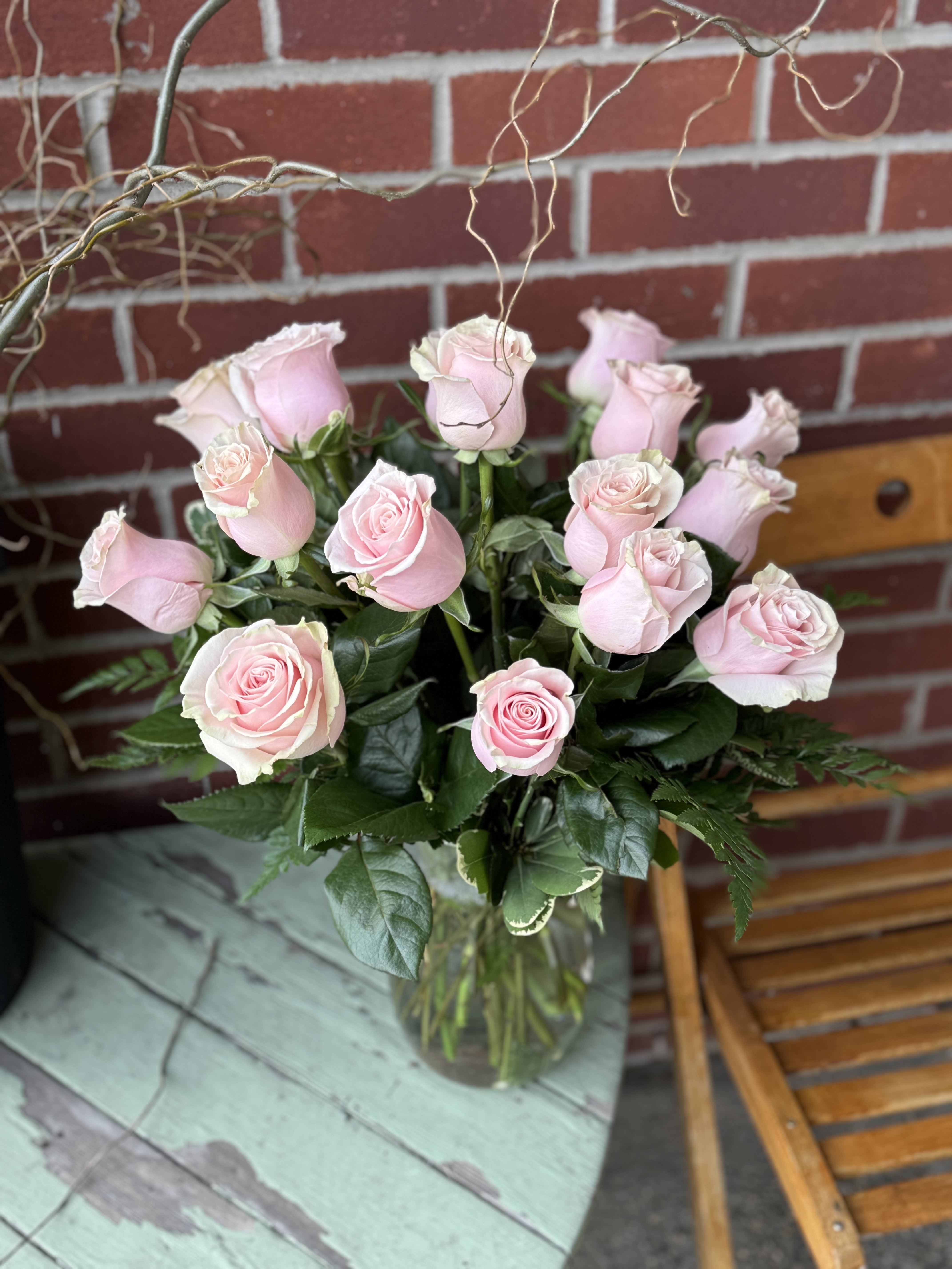 Dozen Pink Mondial Rose Bouquet - Blush Pink Roses are So Beautiful. Our florist design one dozen pink mondial roses compact in a vase with assorted greens and fillers. The meaning of pink roses can stand for femininity, elegance, refinement and sweetness.  A light or pale pink rose conveys grace, gentleness, joy and happiness. "The shade may vary slightly from the photo."