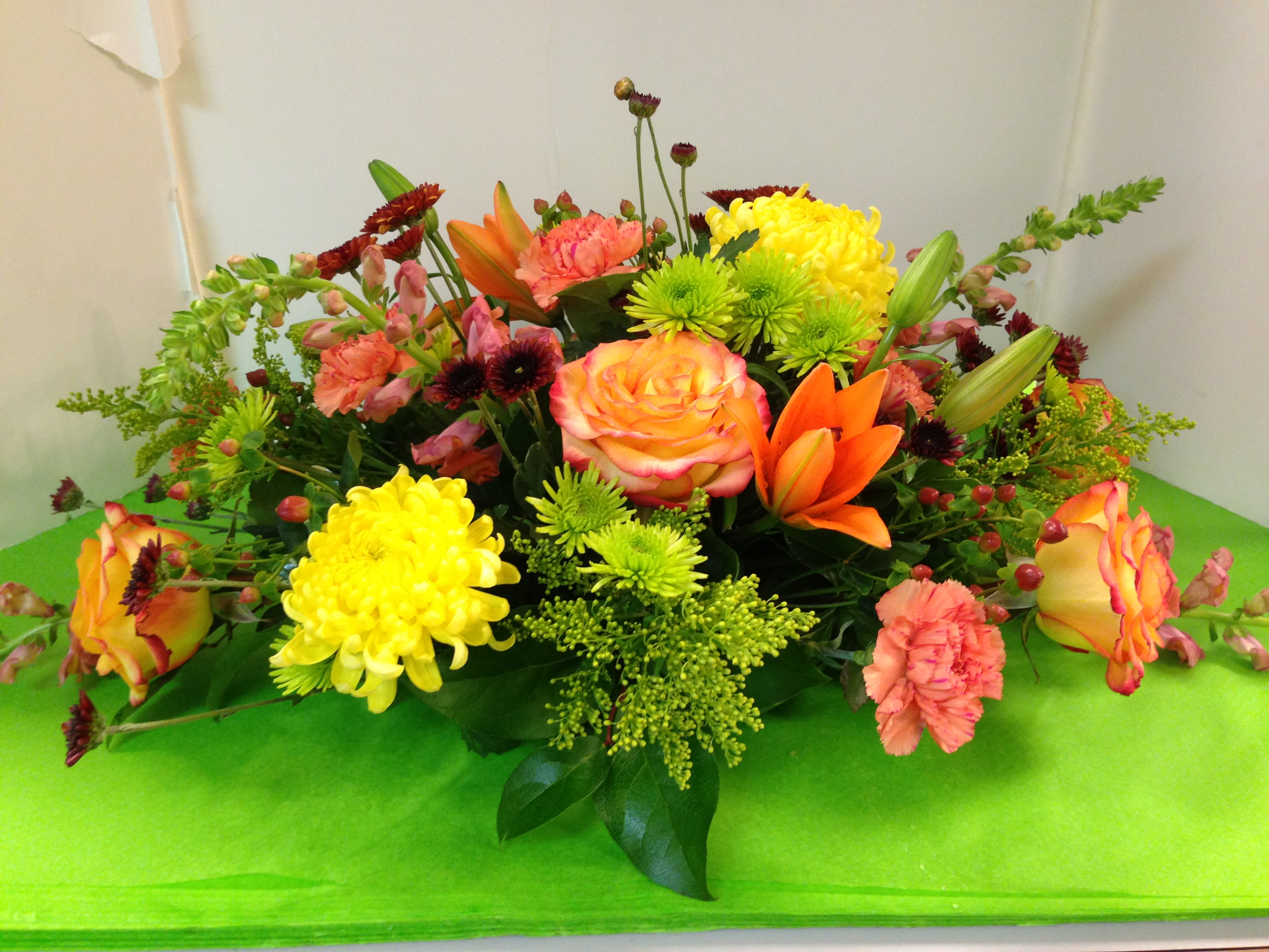 Coffee Table Arrangement - Asiatic Lilies , Mums, Roses,  Alstroemeria, Carnations, Seasonal Flowers, Solidago, Assorted Fancy Greens   CUSTOM  ARRANGEMENTS  CAN BE DONE .  CALL 908-234-2900
