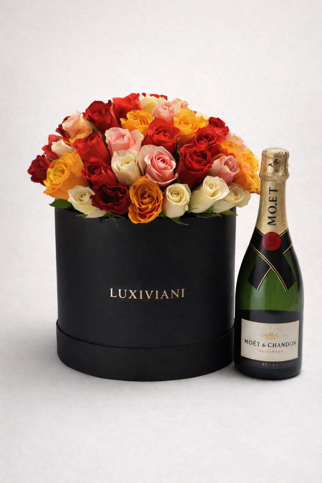 The Golden Moment  - The Golden Moment is a Luxiviani signature designed to honor life’s most meaningful celebrations with elegance and intention. This rose-only arrangement features premium blooms in soft blush, peach, cream, and warm coral hues, artfully styled in our signature hat box for a full, refined presentation.  Paired with a bottle of Moët Champagne, this luxury gift set is perfect for toasting milestones, love, and unforgettable moments.  Finished with Luxiviani’s signature details for a polished, elevated experience. 
