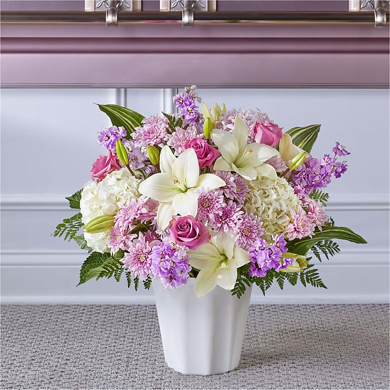 Heaven Sent Floor Basket - Blessings and prayers sent from above are captured in this stunning lavender and white arrangement. Each gorgeous bloom in our Heaven Sent Floor Basket is designed to bring solace during difficult times. While the lilies may initially arrive in bud form, they beautifully transform as they open.