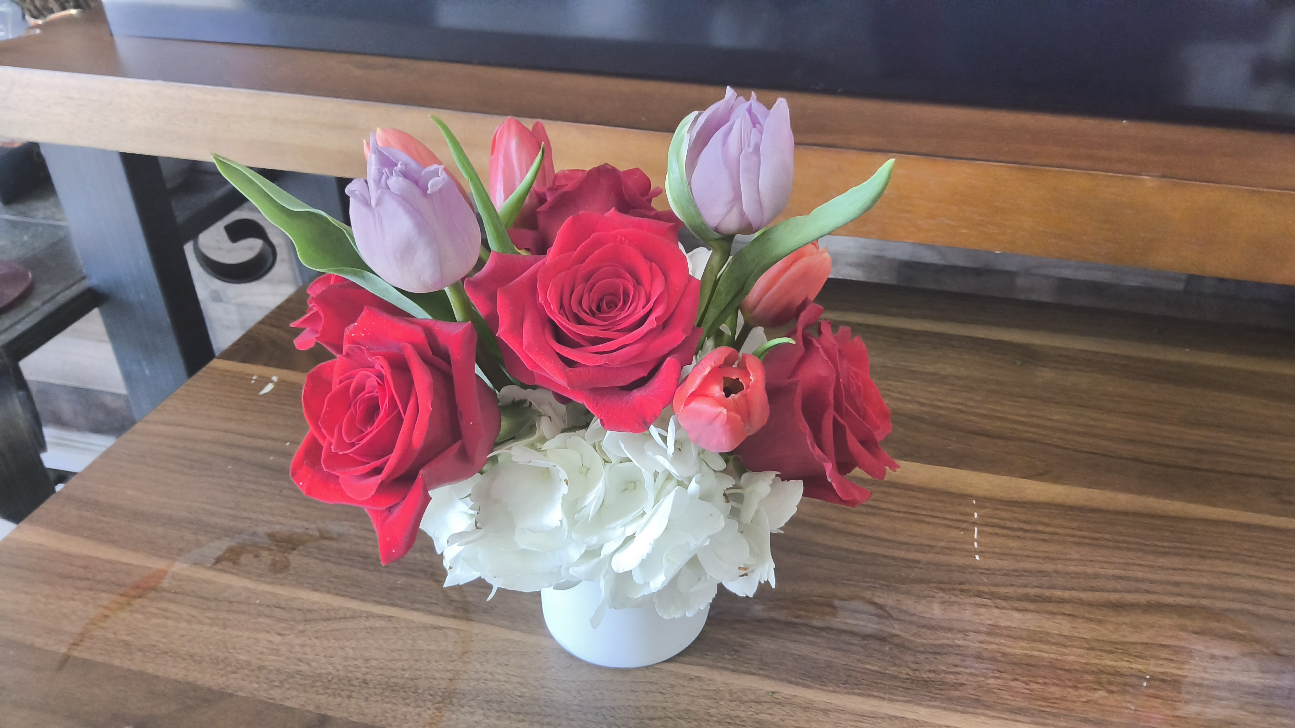 Tulips and rose delight  - Beautifully arranged tulips and roses in a white cylindrical vase with white hydrangeas 