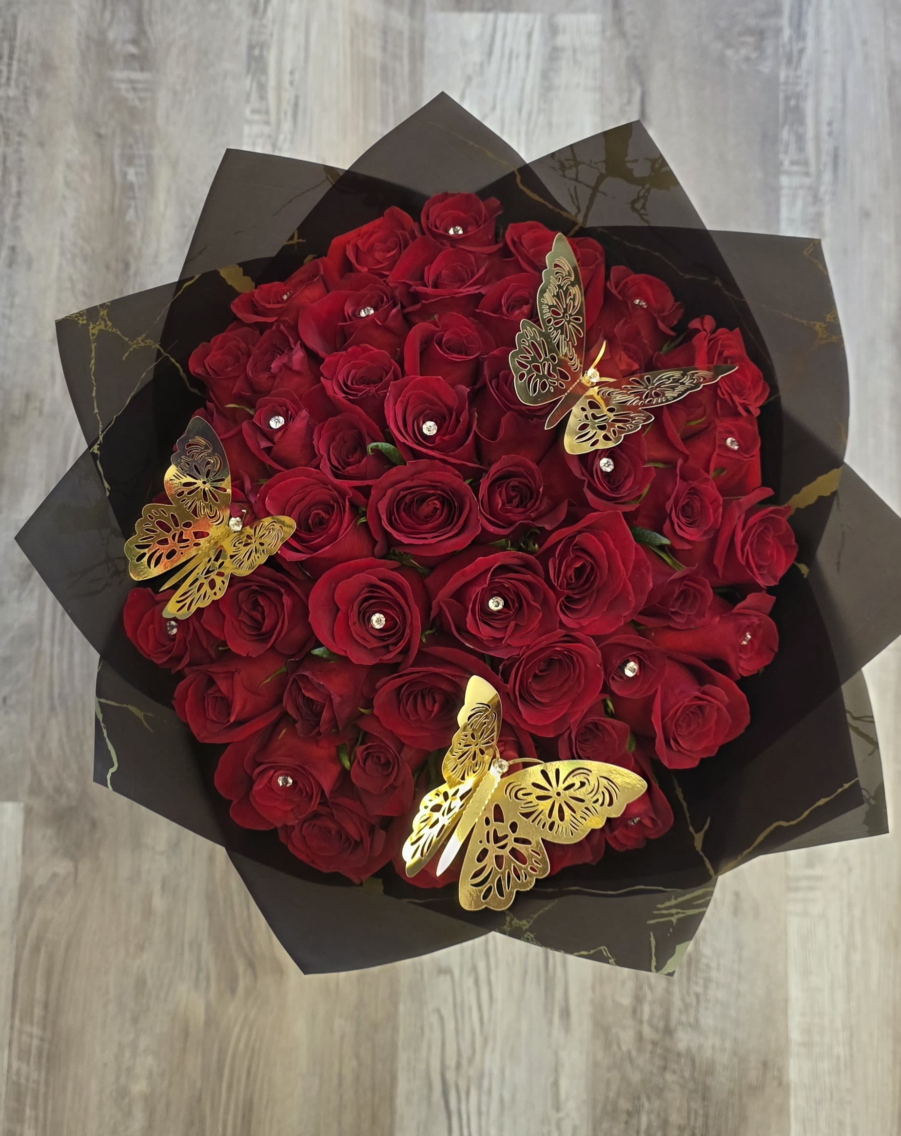 V Day Rose Bouquet 1 - Our 50/75/100 Stem Rose Bouquet with Diamond &amp; Butterfly delivers elegance, romance, and wow-factor in every bloom. Limited availability – order early!  If you would like to customize a rose bouquet please contact us today at 772-249-5688 