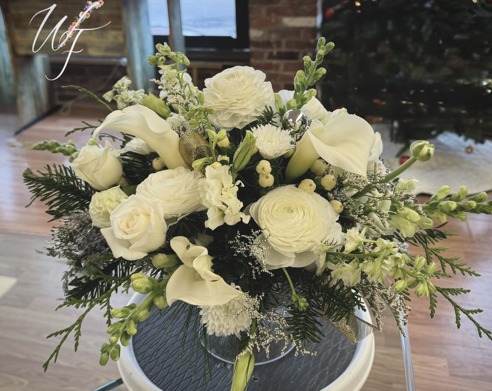 Winter Elegance  - Clean white blooms and evergreens accent this compote vase for a gorgeous table piece 