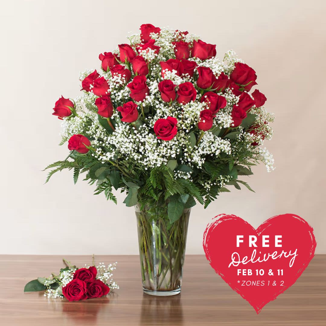 Abundant Love (The HAMMAH! with 4 Dozen Long Stem Roses) - Introducing "The Hammah"! This amazing piece features 48 stems of premium long stem red roses elegantly arranged with accent greens in a special glass vase. Spoil the love of your life with this grand and luxurious arrangement that creates a "Drop the Mic" moment when delivered.    Key Features:    Premium Long Stem Red Roses: 48 stems of exquisite long stem red roses, symbolizing deep love and passion.    Elegant Arrangement: Expertly designed with accent greens to enhance the beauty and sophistication of the roses.    Special Glass Vase: Presented in a unique and special glass vase, adding to the grandeur and elegance of the arrangement.    Perfect for Special Occasions: Ideal for making a statement on anniversaries, Valentine's Day, or any occasion where you want to express deep love and admiration.    Luxurious Gift: Spoil your loved one with this luxurious and breathtaking floral arrangement that promises to leave a lasting impression.    Give "The Hammah" and create a memorable "Drop the Mic" moment with this stunning display of 48 premium long stem red roses, designed to convey your love and affection in the most grand and elegant manner.