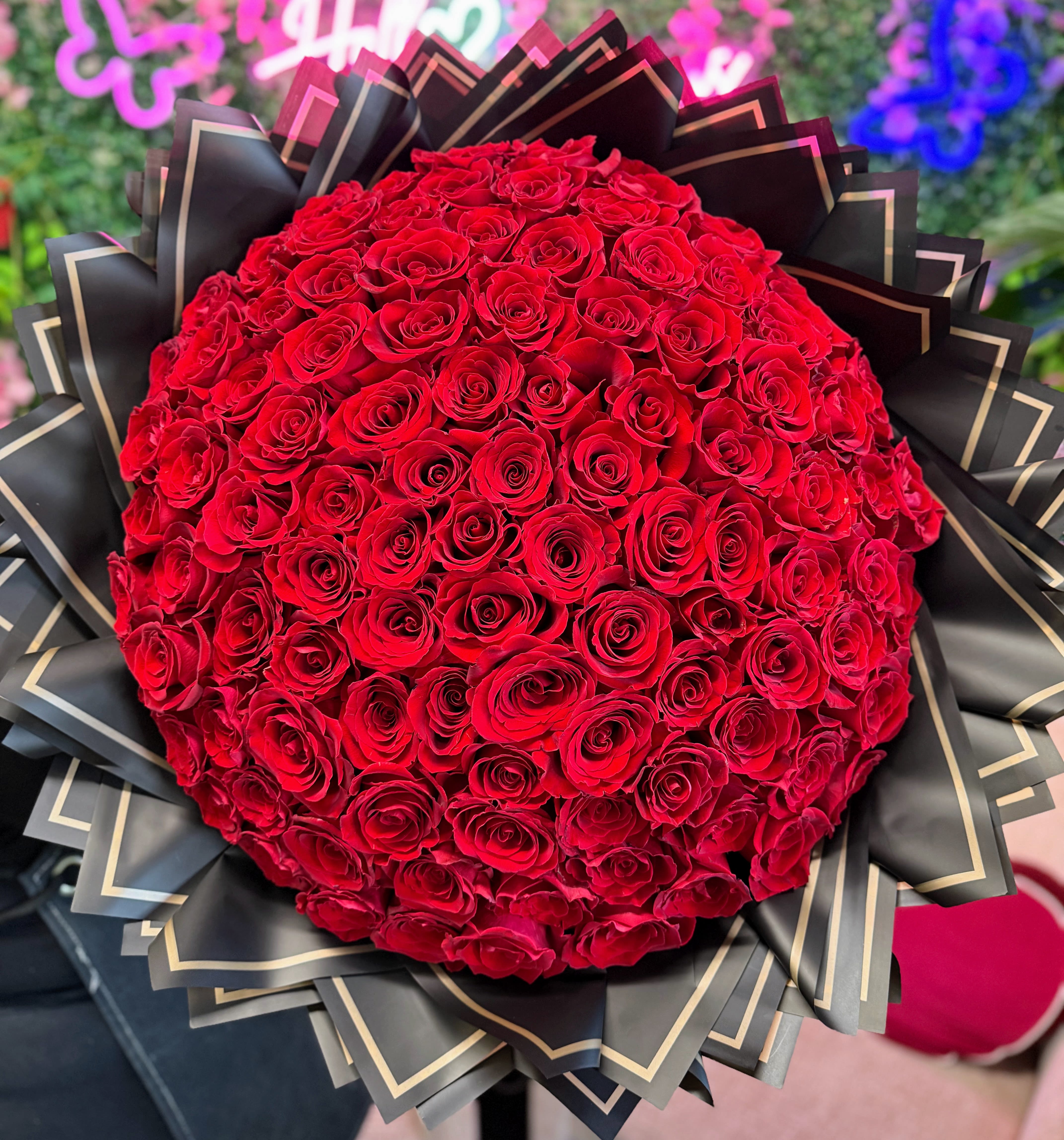 Grand Red Roses Wrapped  Bouquet (100, 150, 200 Roses)  - STANDARD 100 ROSES DELUXE 150 ROSES PREMIUM 200 ROSES Red rose bouquet is a captivating arrangement, designed to exude romance, elegance with a touch of glamour! The bouquet features lush, deep premium red roses.