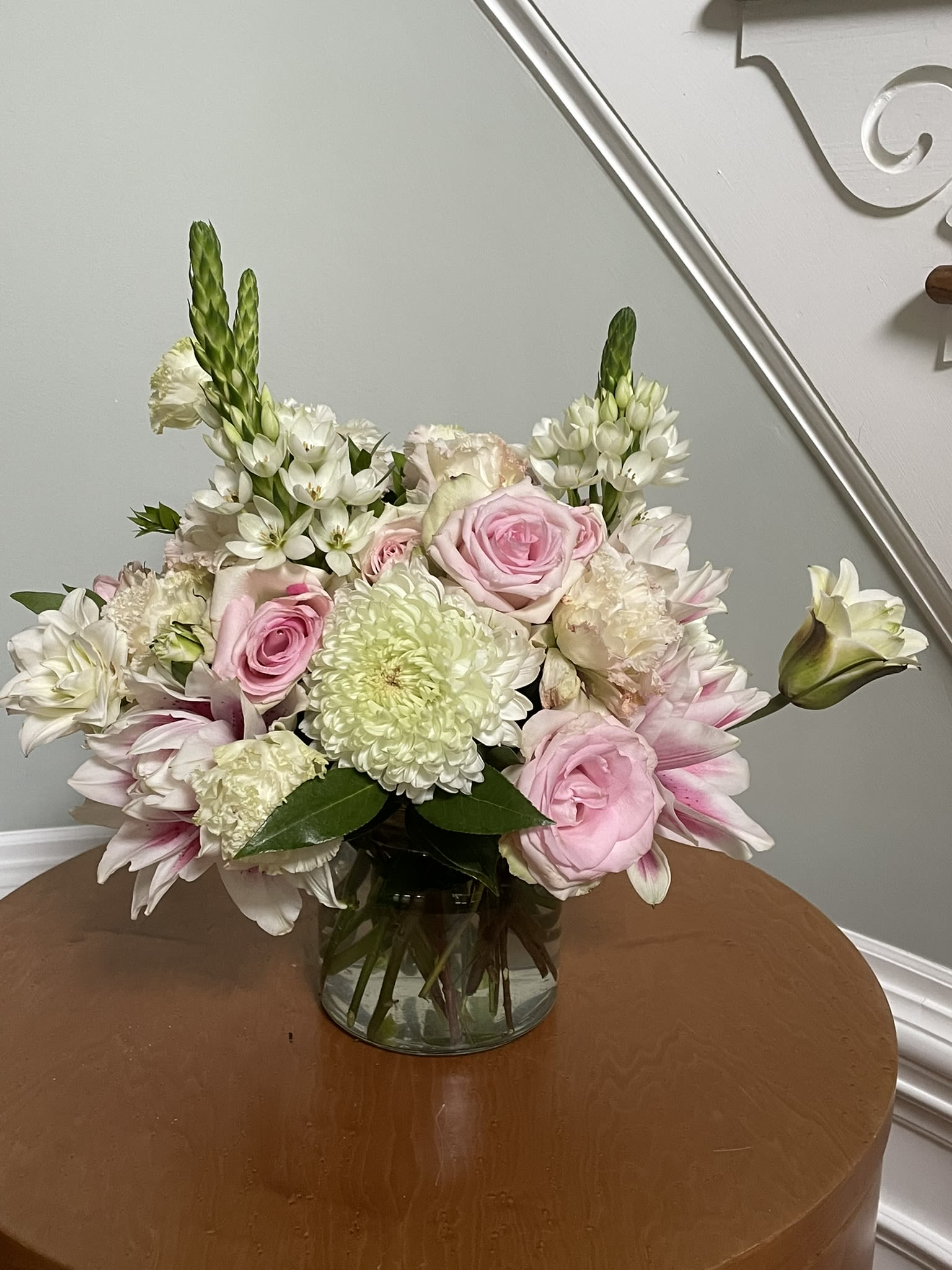 Pink Innocence - Soft pink roses, rose lilies, Stars of Bethlehem, and white lisianthus are arranged to create a lasting glow of innocence, kindness, and grace. Ideal for occasions ranging from bridal and baby showers, birthdays and anniversaries, to get well and sympathy - but mostly "just because."