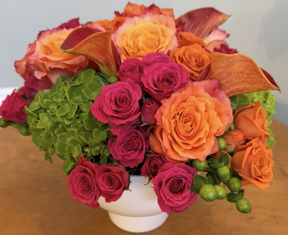 Spring Fling - Enjoy the magic of spring anytime with this gorgeously vibrant collection of garden roses, mini callas, hydrangea, spray roses, and hypericum. This arrangement is ideal for anyone who appreciates rich color or needs a boost of happiness, and is appropriate for every occasion. Can be upgraded to include dahlias, ranunculus, peonies, and tulips.