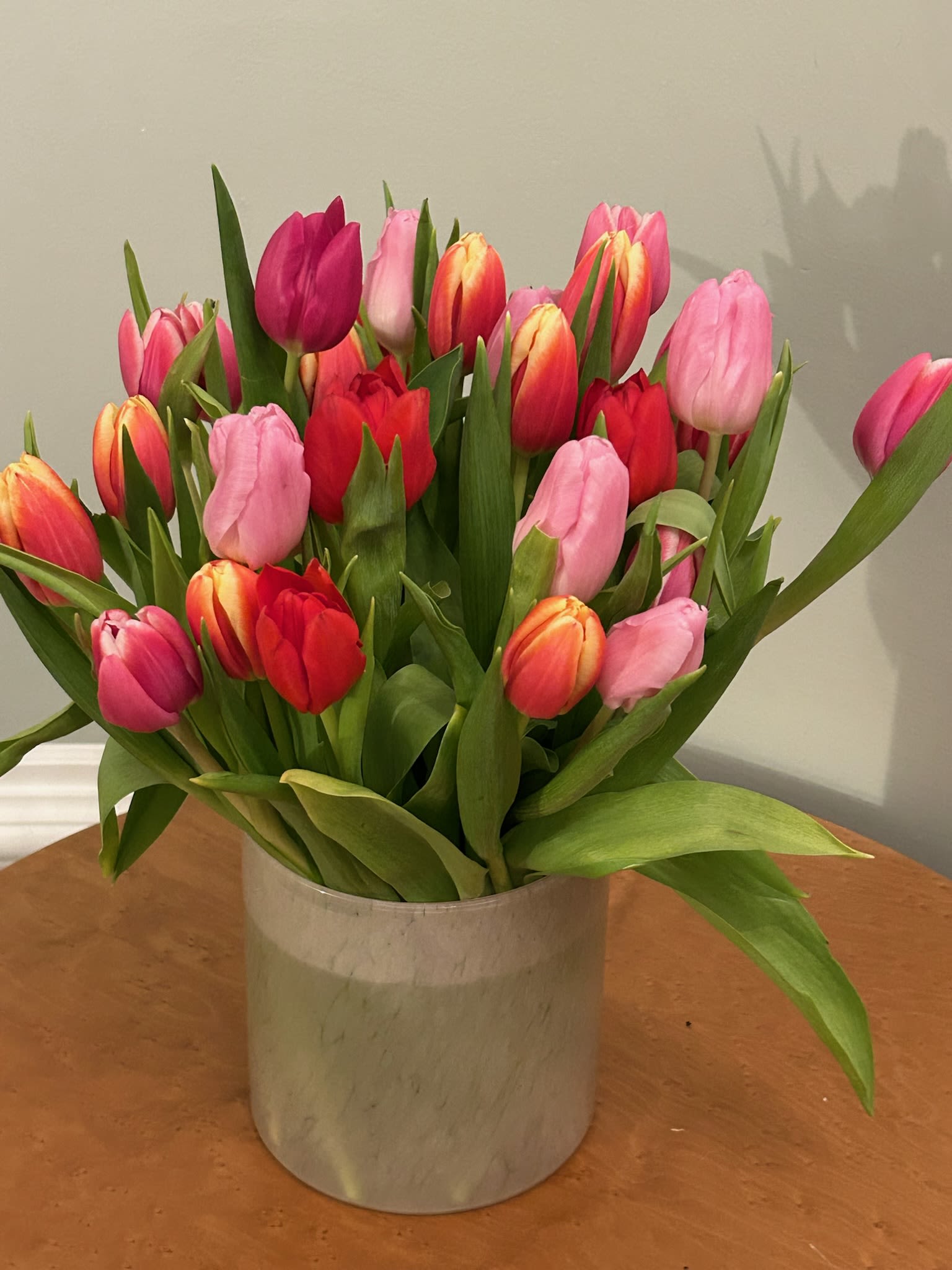 Tulip Temptation - No one can resist a mass of colorful tulips, each one opening at its own pace and style. Symbolizing new beginnings and prosperity, these flowers are cheerful and stunning simply on their own. The standard arrangement has between 25-30 tulips, and increases in quantity with each upgrade.