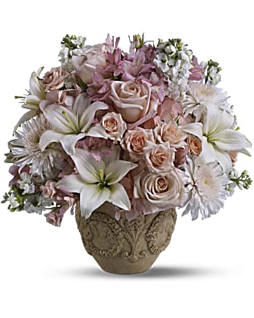 Garden of Memories - A classic Grecian-style urn lends a time-honored touch to these feminine sympathy flowers. Light pink roses and large white lilies create an unforgettable garden of grace and love. Pink blooms such as hydrangea, roses and alstroemeria are mixed with white flowers including stock, asiatic lilies and white Cremon chrysanthemums. Delivered in Teleflora's exclusive Garlands of Grace urn. Orientation: All-Around