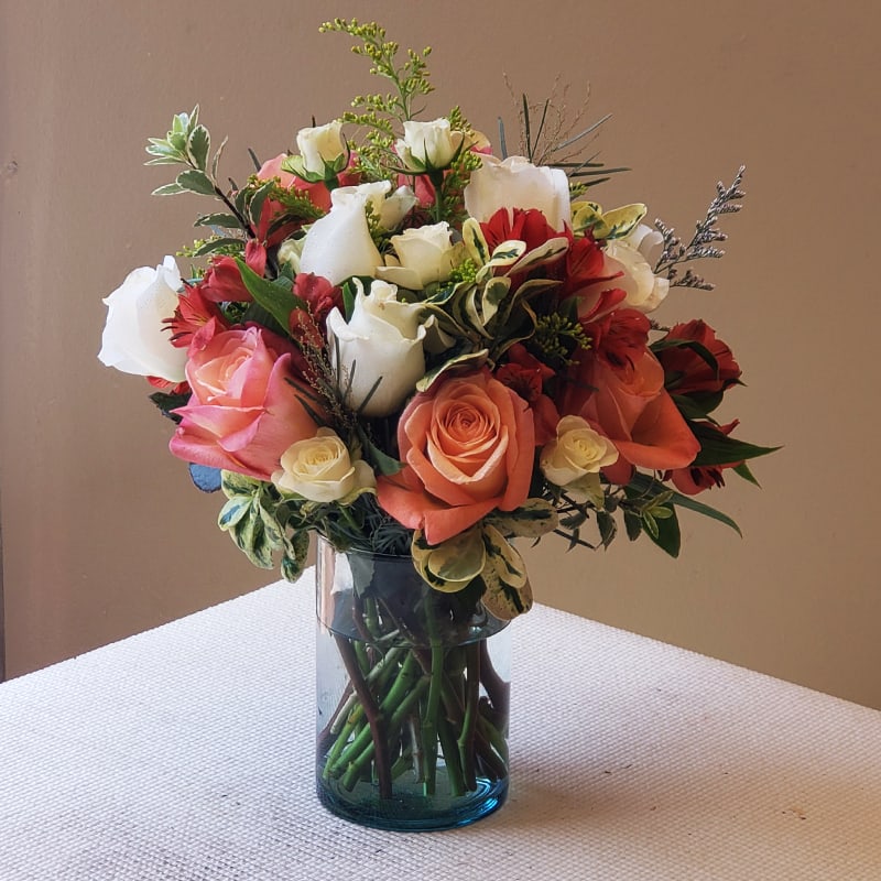 Spring Remixed Blooms - Our Spring Remixed bouquet is a classic bouquet that beautifully balances the warmth of orange and pink roses with the purity of white roses,  presented in a simple glass vase.   It's  a perfect gift for expressing love, and gratitude, or for gracing any special occasion.  Approximately 16" H X 14" W. Gift someone this bouquet now! 