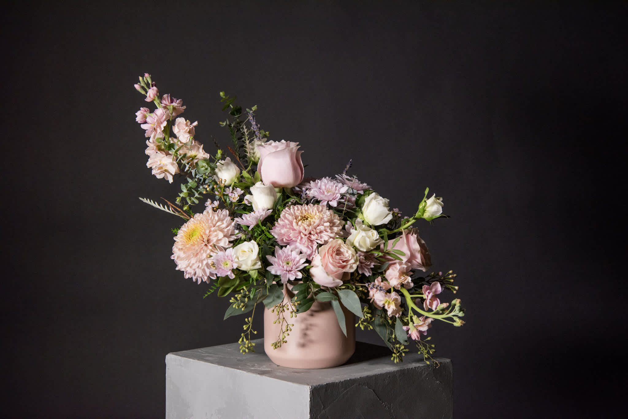 Jaipur, Wanderlust Series - Ceramic Pot Arrangement - Inspired by the enchanting pink city of India, this soft and misty arrangement captures the essence of Jaipur's timeless allure. Delicate roses, chrysanthemums, dried lavender, matthiola, and seeded eucalyptus come together to evoke a sense of dreamy elegance, inviting you to wander through its charm and imagine distant horizons.  Pot size : 4.25in X 4.25in