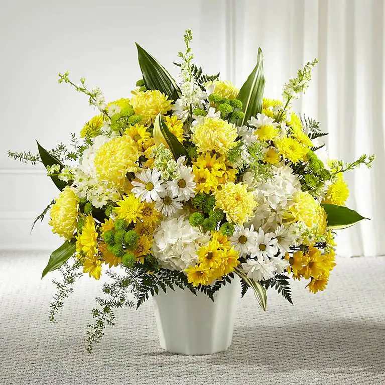 Unity &amp; Grace Floor Basket - Every bloom in our Unity &amp; Grace™ Floor Basket reminds us of the brightness of their spirit. This stunning arrangement features an uplifting mix of hydrangea, larkspur, daisy pompons and mums. Each arrangement is handcrafted and hand delivered by a local florist, making it a touching gesture for loved ones.