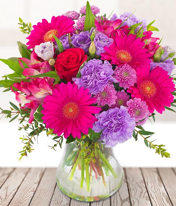 Sweet Bouquet - Bring a little sunshine into their new home with a stunning bouquet packed full of bright flowers, with popping pink germini, purple carnations and roses. 