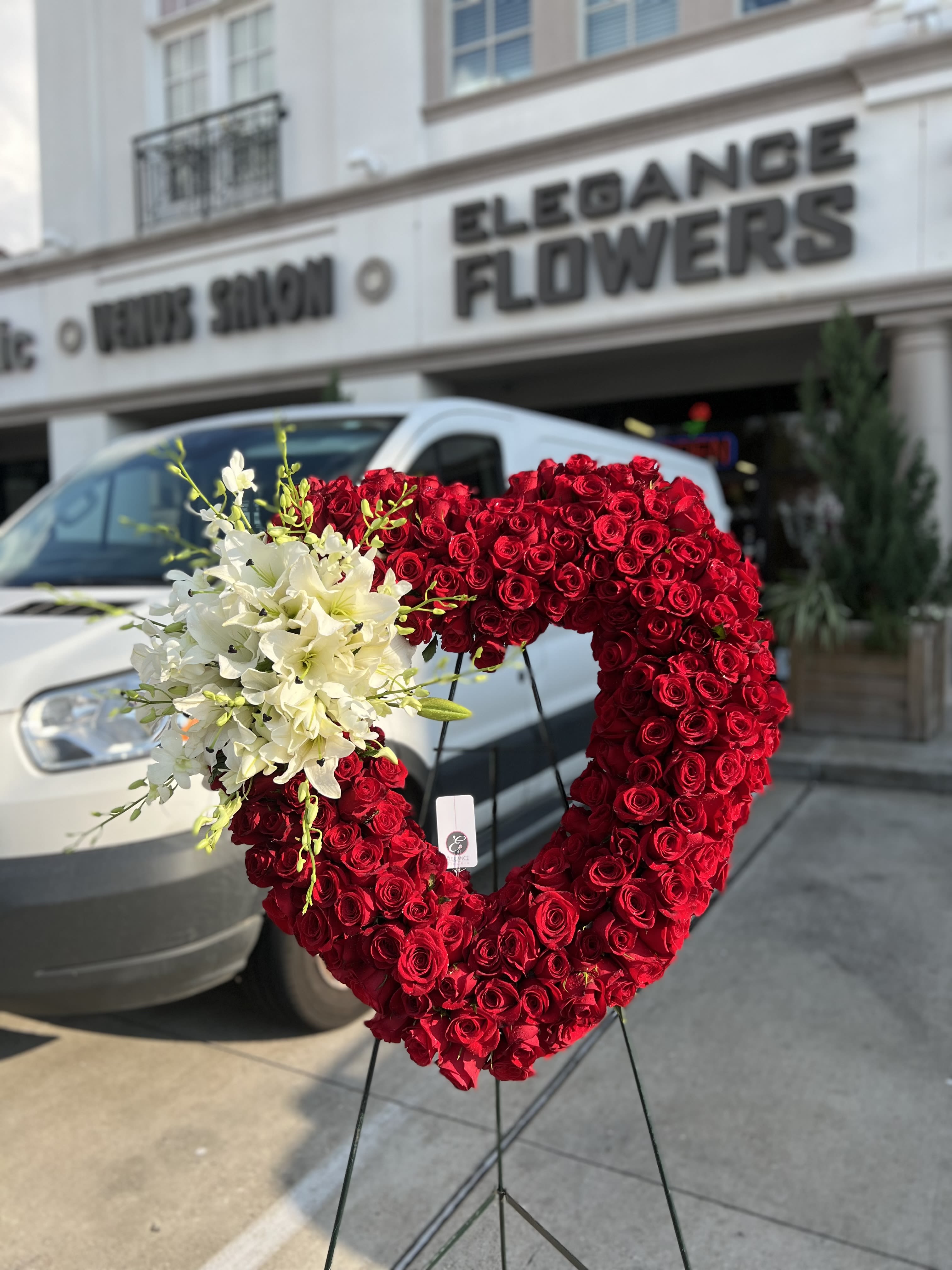 Heart Wreath #7 - A standings flower arrangement for a funeral service is a heartfelt tribute designed to honor and celebrate the life of the deceased. These arrangements are typically displayed on an easel or stand, making them highly visible and a central part of the memorial decor.