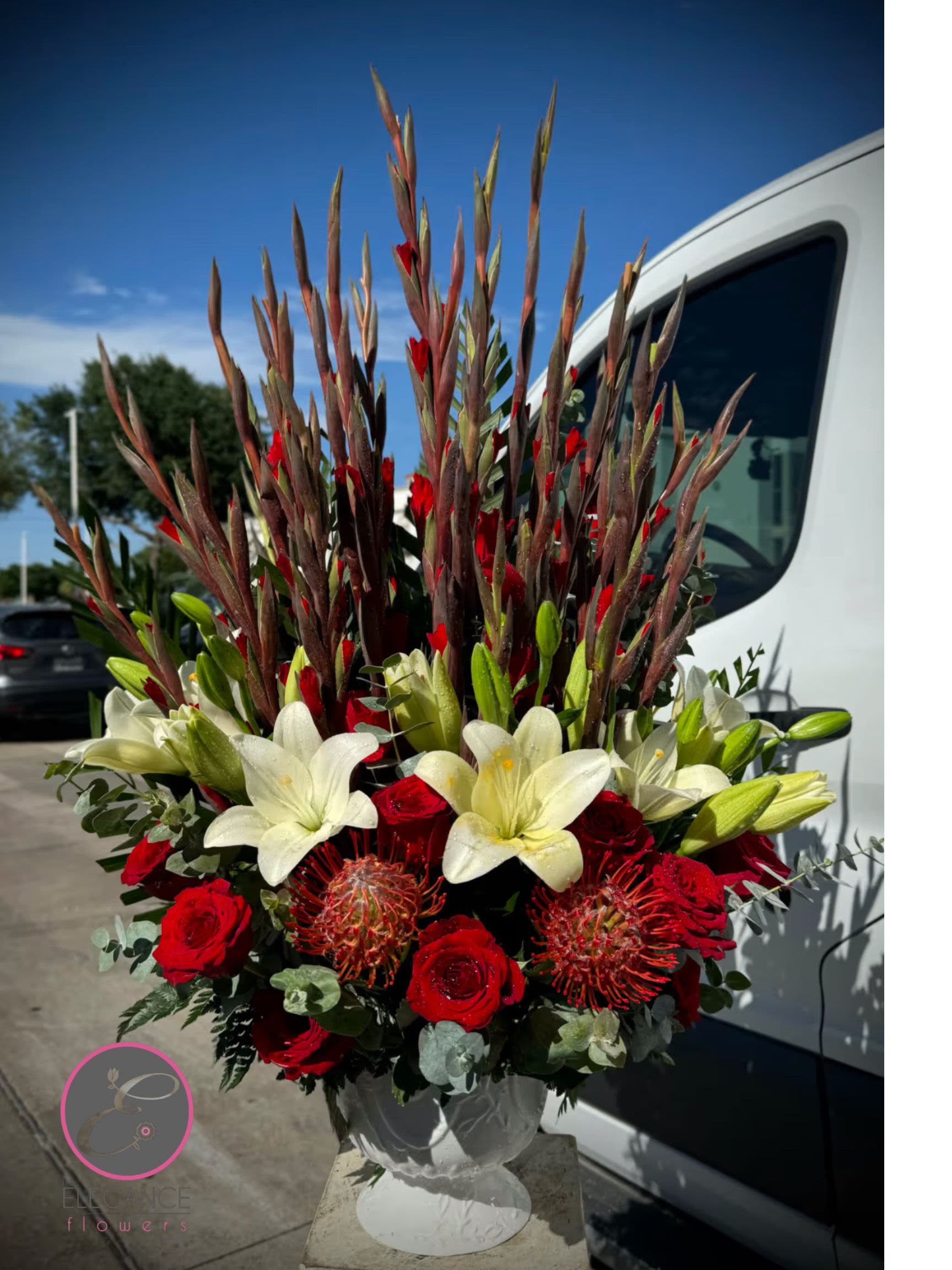 Pedestal Arrangement #2 - A basket flower arrangement for any occasion features a beautiful selection of fresh blooms in a decorative basket. These versatile arrangements can be a heartfelt gesture during difficult times.