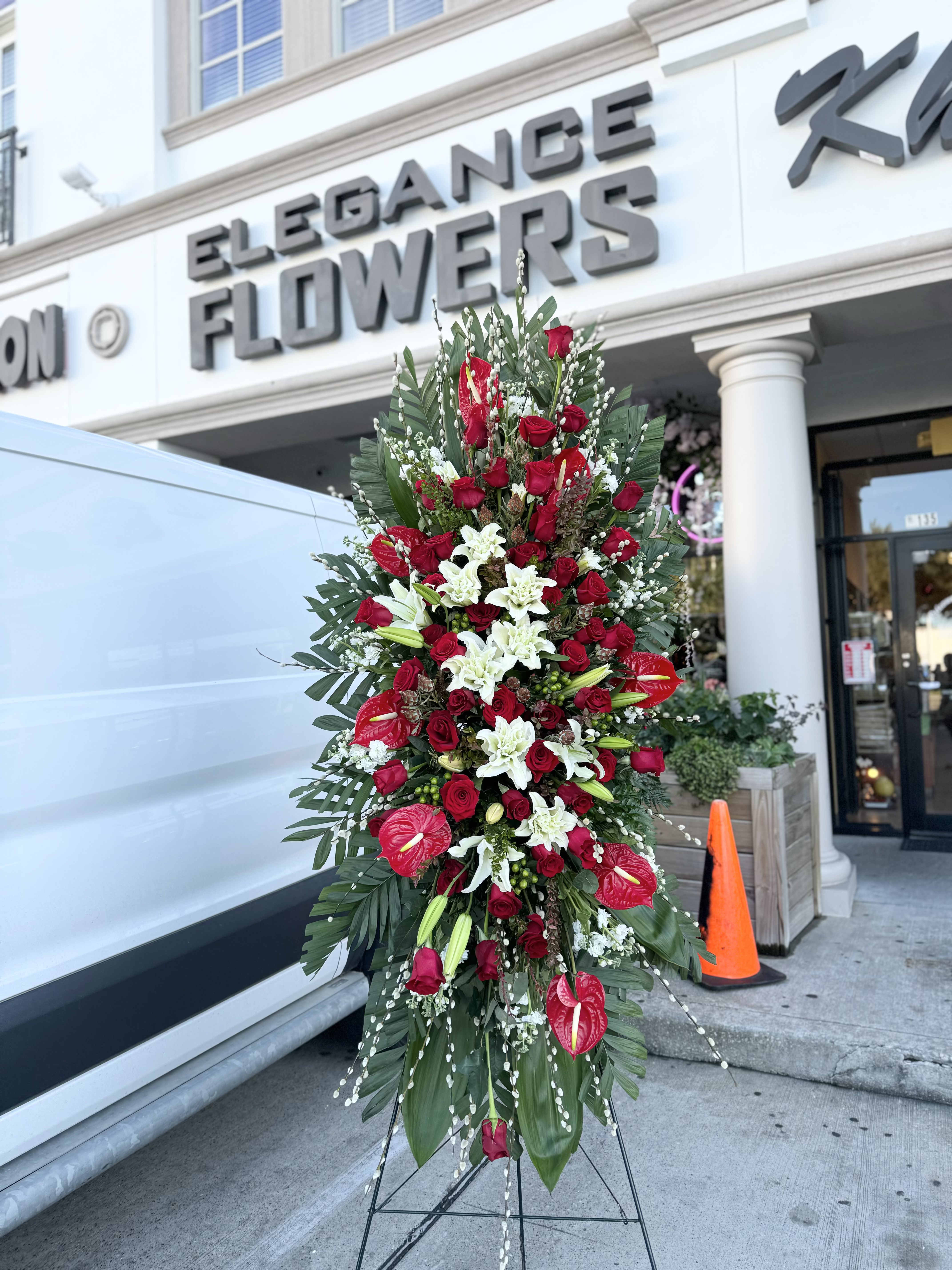 Easel #13 Online  - A standings flower arrangement for a funeral service is a heartfelt tribute designed to honor and celebrate the life of the deceased. These arrangements are typically displayed on an easel or stand, making them highly visible and a central part of the memorial decor.
