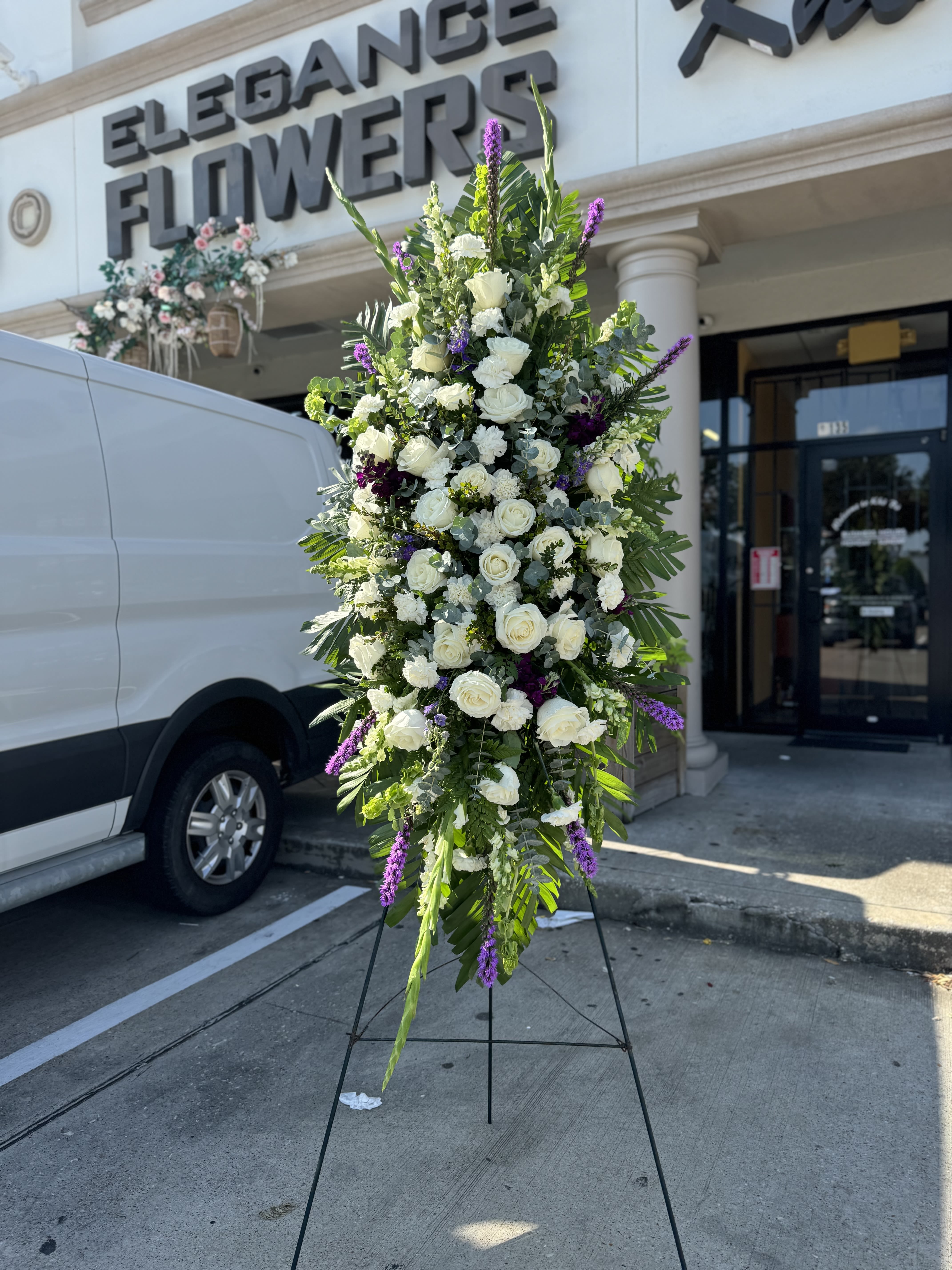 Easel #18 Online - A standings flower arrangement for a funeral service is a heartfelt tribute designed to honor and celebrate the life of the deceased. These arrangements are typically displayed on an easel or stand, making them highly visible and a central part of the memorial decor.
