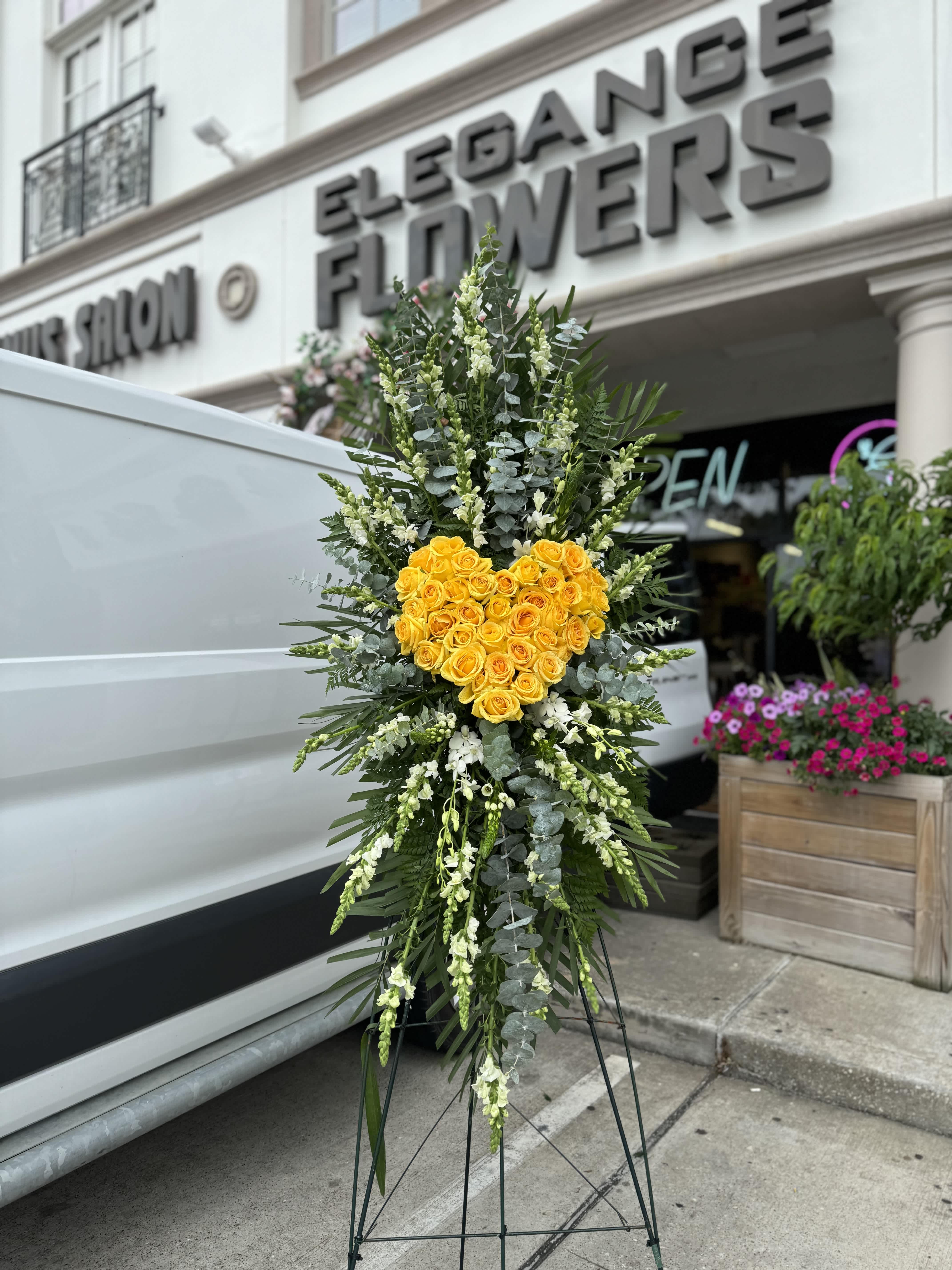 Easel #30 Online  - A standings flower arrangement for a funeral service is a heartfelt tribute designed to honor and celebrate the life of the deceased. These arrangements are typically displayed on an easel or stand, making them highly visible and a central part of the memorial decor.
