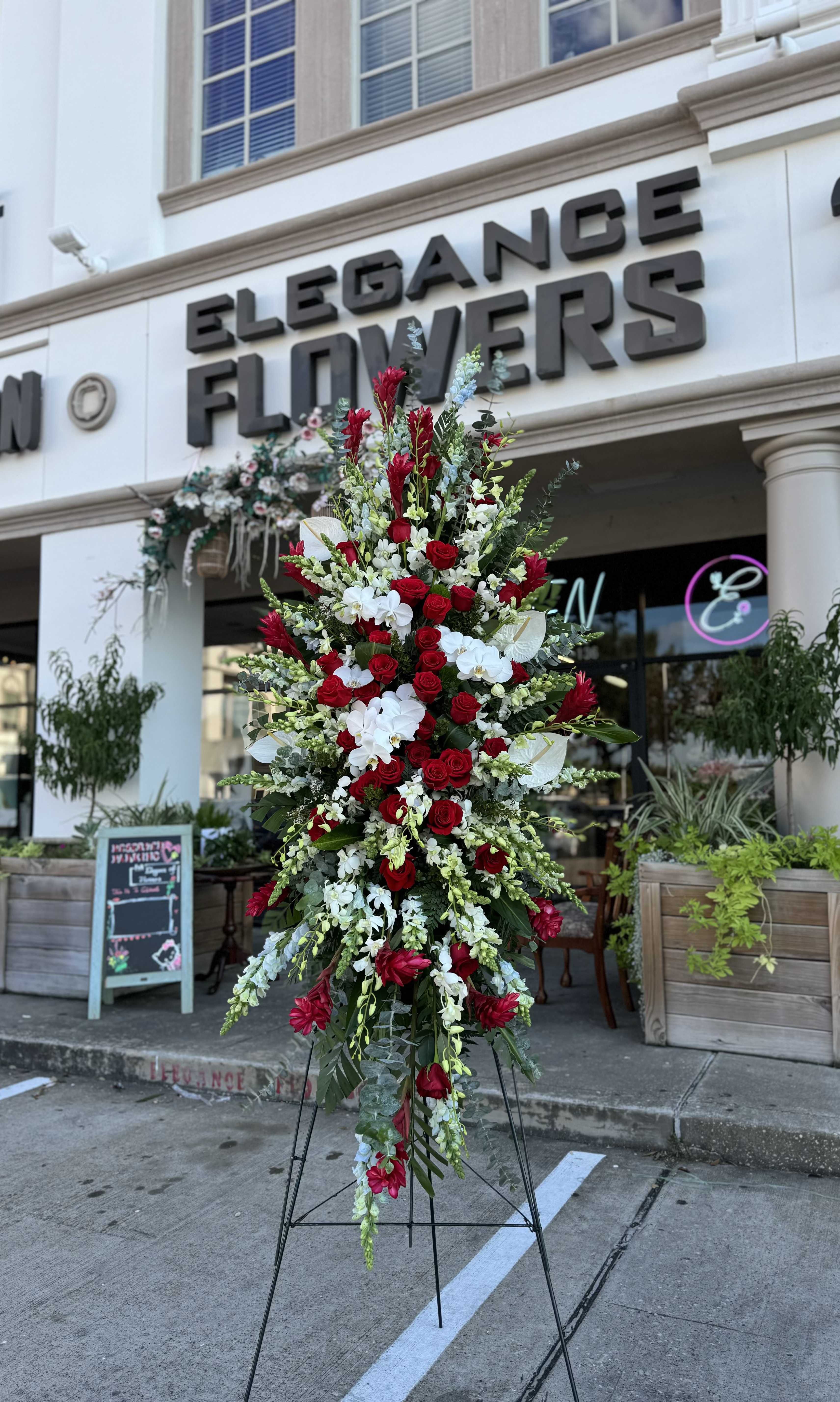 Easel #22 Online - A standings flower arrangement for a funeral service is a heartfelt tribute designed to honor and celebrate the life of the deceased. These arrangements are typically displayed on an easel or stand, making them highly visible and a central part of the memorial decor.