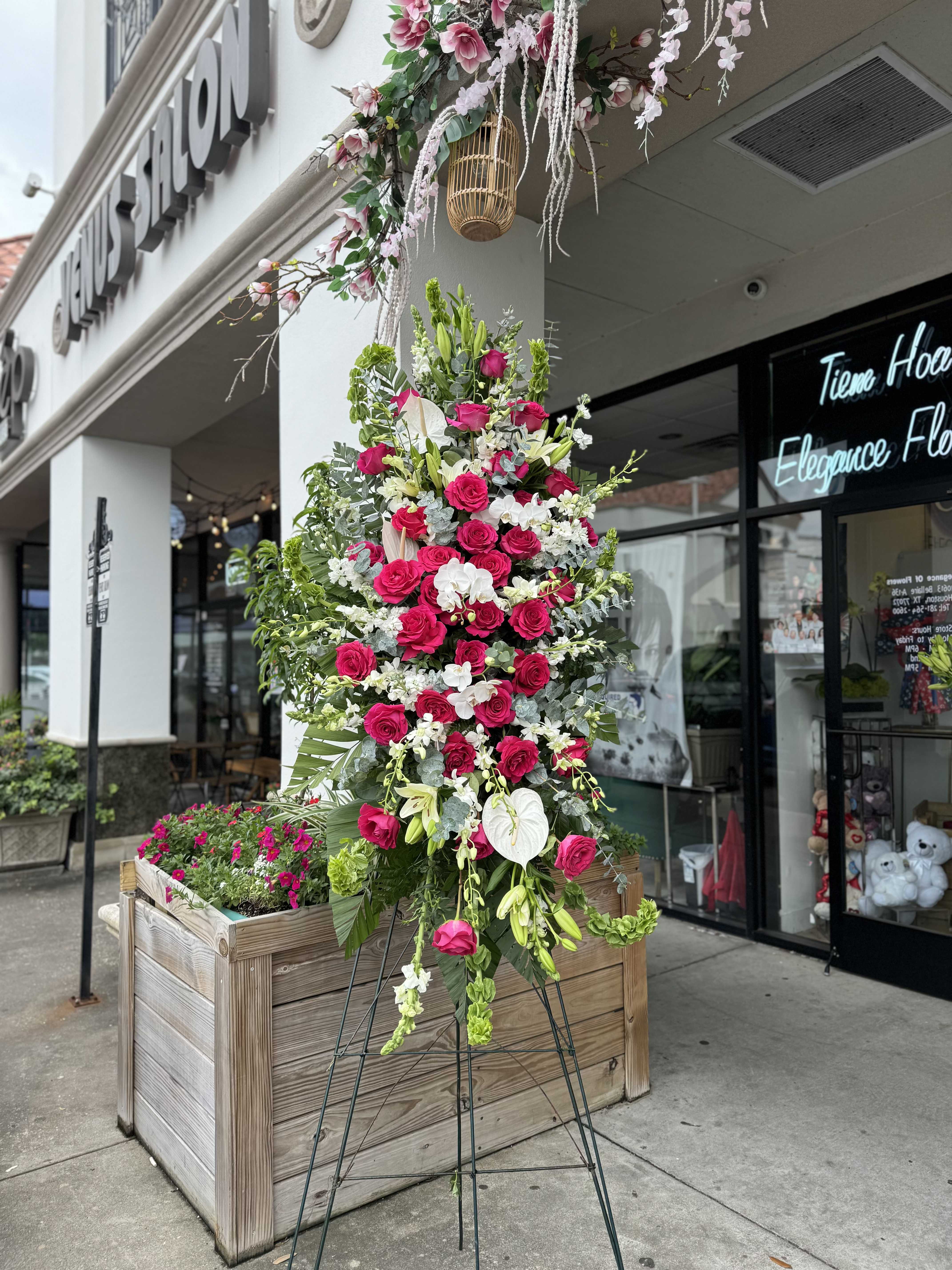 Easel #24 Online - A standings flower arrangement for a funeral service is a heartfelt tribute designed to honor and celebrate the life of the deceased. These arrangements are typically displayed on an easel or stand, making them highly visible and a central part of the memorial decor.