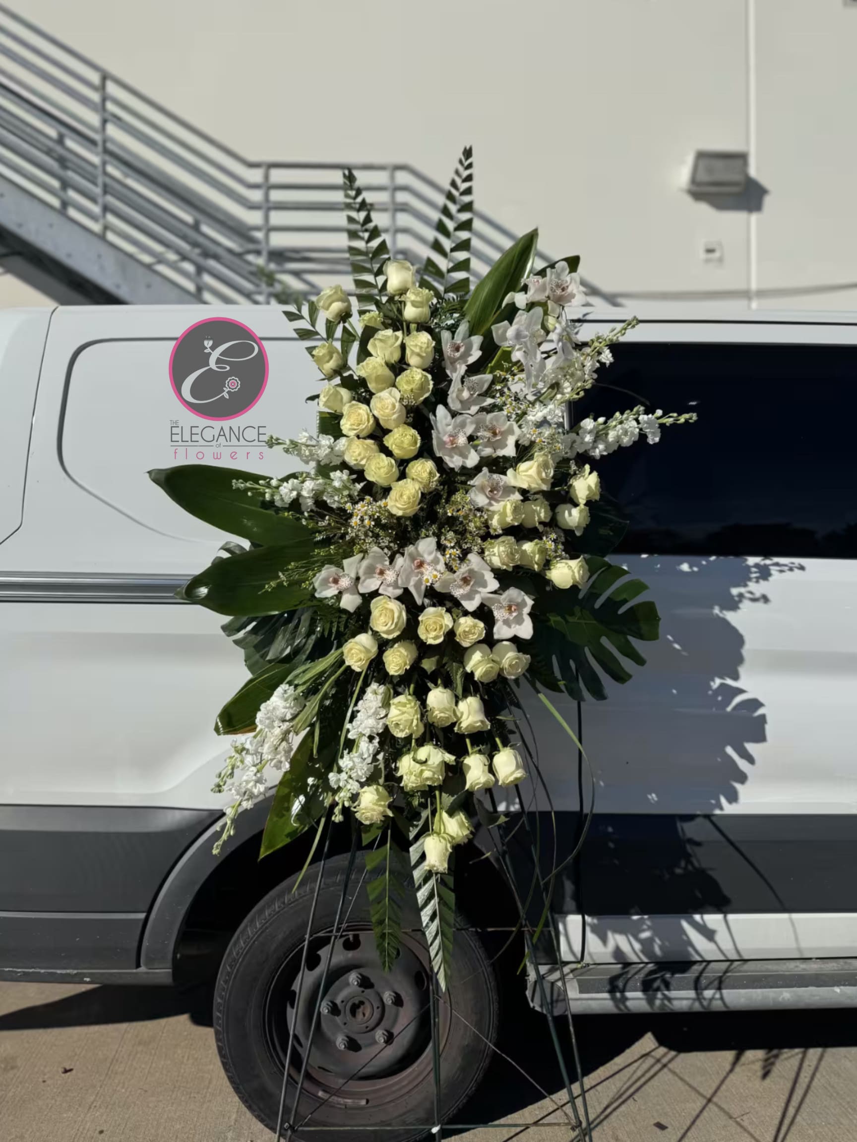 Easel #7 Online - A standings flower arrangement for a funeral service is a heartfelt tribute designed to honor and celebrate the life of the deceased. These arrangements are typically displayed on an easel or stand, making them highly visible and a central part of the memorial decor. 