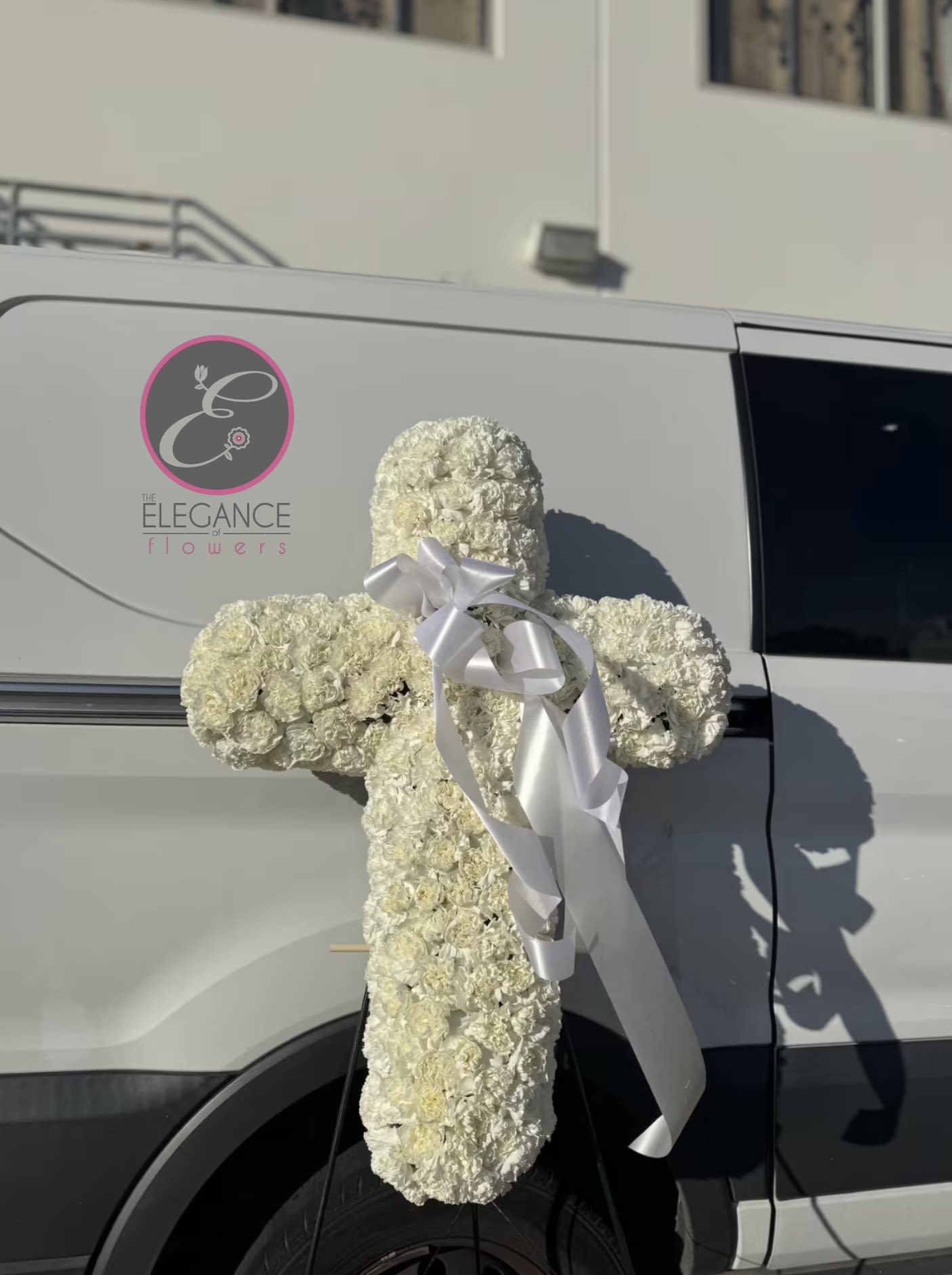 Cross Stand #10 -  cross stand for a funeral is a graceful tribute, symbolizing faith and remembrance. Adorned with fresh flowers, it stands as a comforting centerpiece during memorial services.