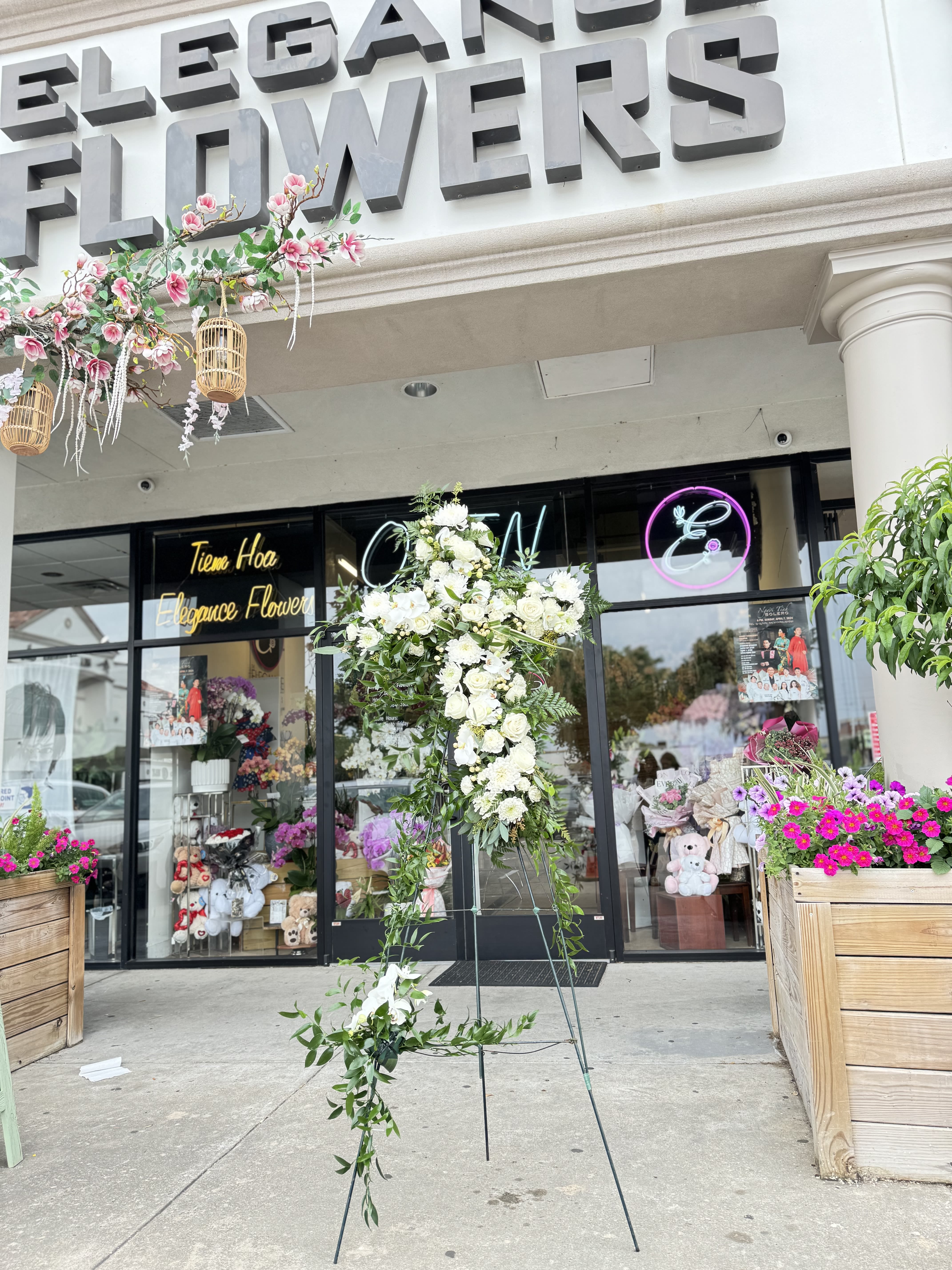 Cross Stand #2 - A cross stand for a funeral is a graceful tribute, symbolizing faith and remembrance. Adorned with fresh flowers, it stands as a comforting centerpiece during memorial services.