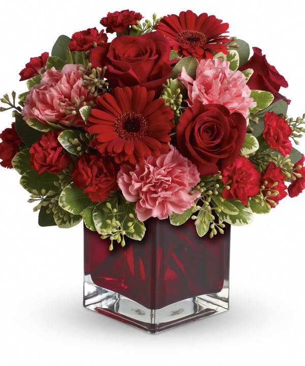 Together Forever  Bouquet - Perfect for your valentine. This arrangement is designed in a red cube and includes red roses, pink carnations, red gerbera daisies and mini red carnations.