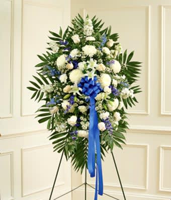 Blue &amp; White Sympathy - White Lilies, roses, mums, and carnations with blue delphinium and a blue bow