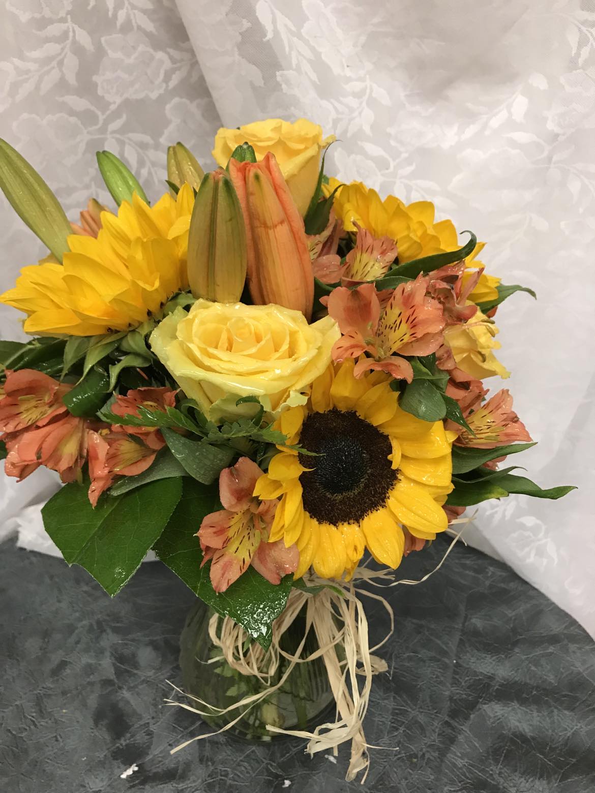 Autumn Sky - SUNFLOWER, ROSES MUMS IN GLASS VASE WITH RAFIA BOW