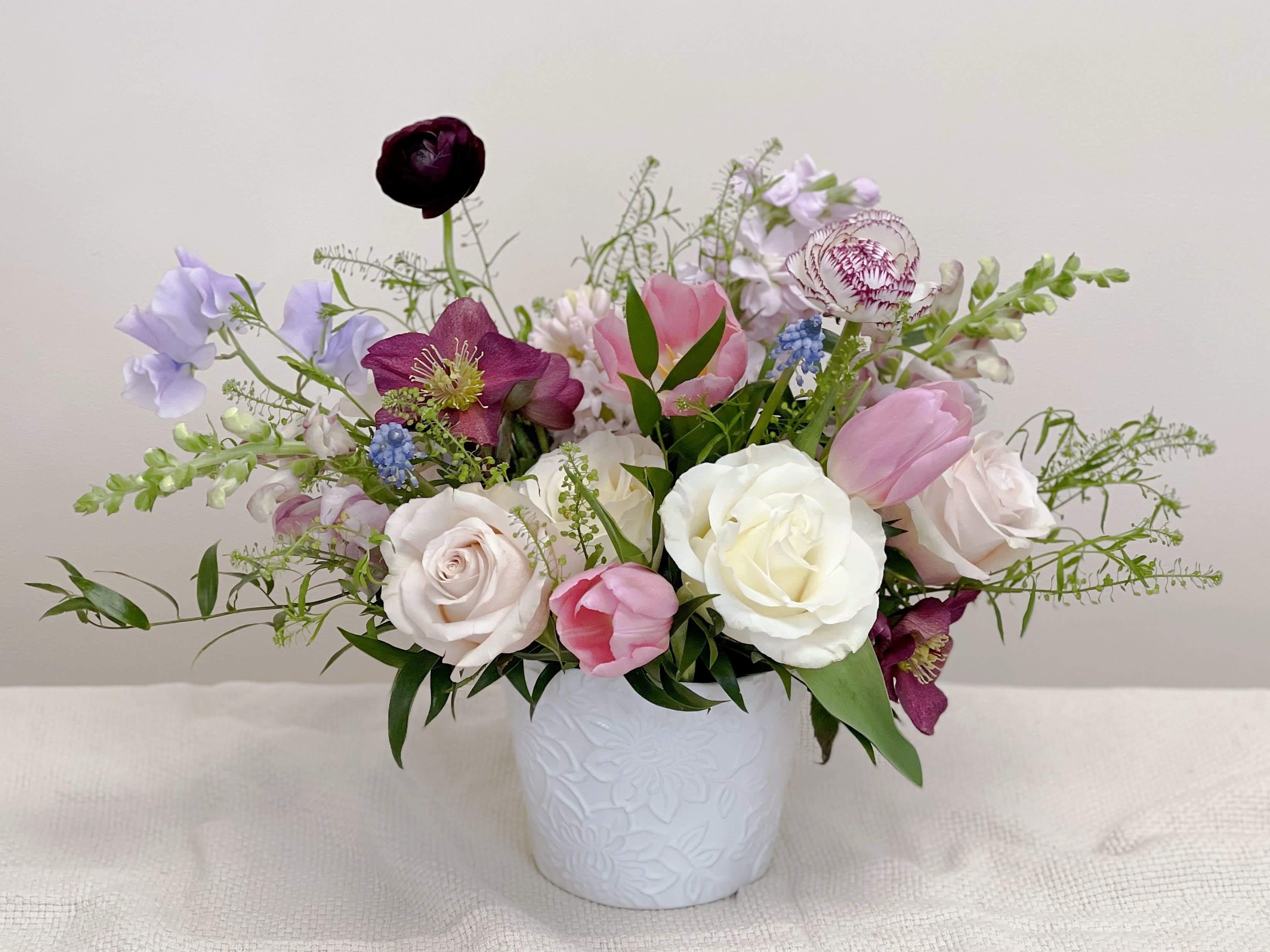 A Walk in the Garden - An arrangement full of fragrant spring blooms in a low vase, with lots of texture and movement reminiscent of a spring garden.  