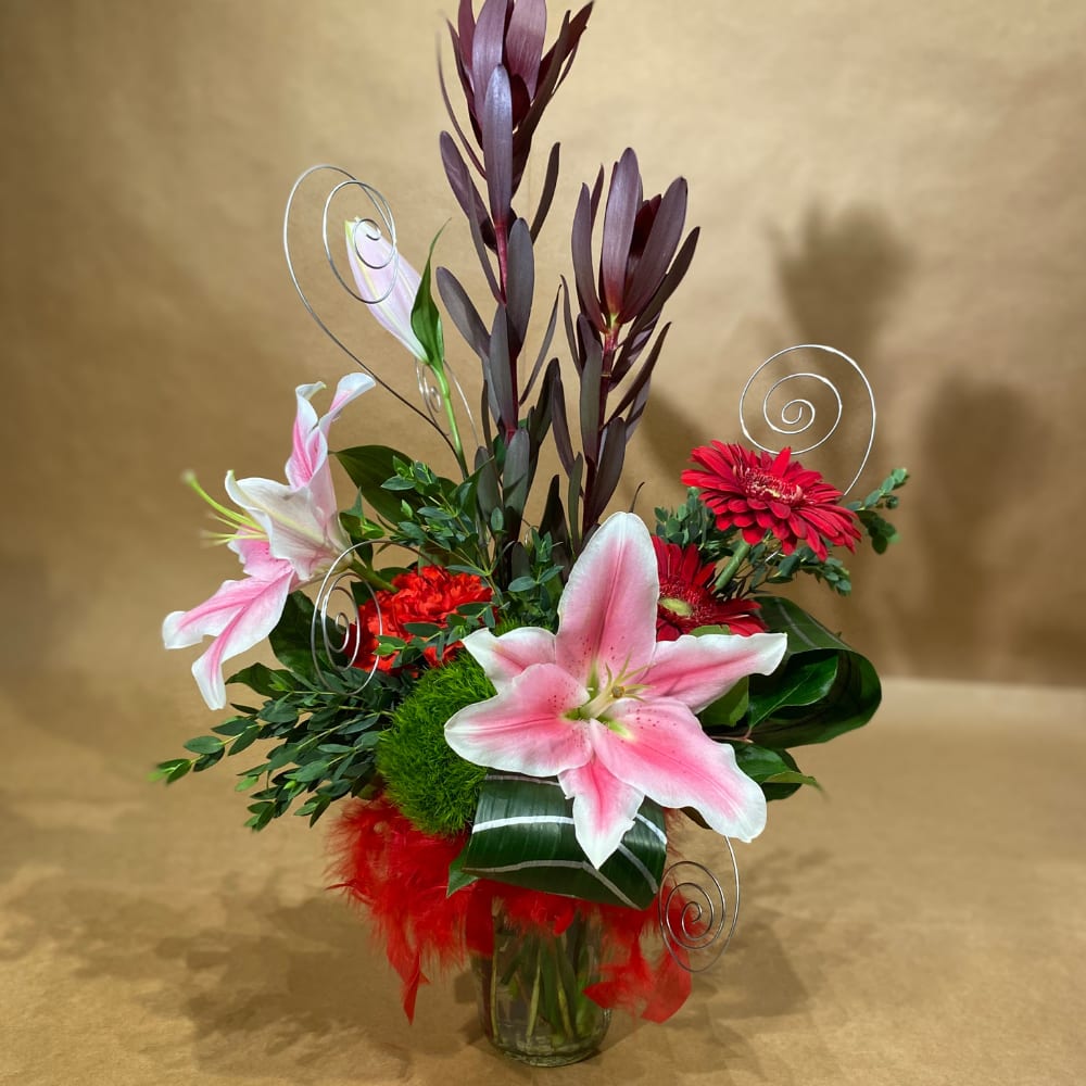 Sassy Love - A changing mix of red and dark pink flowers with feather boa, painted leaves and wire swirls