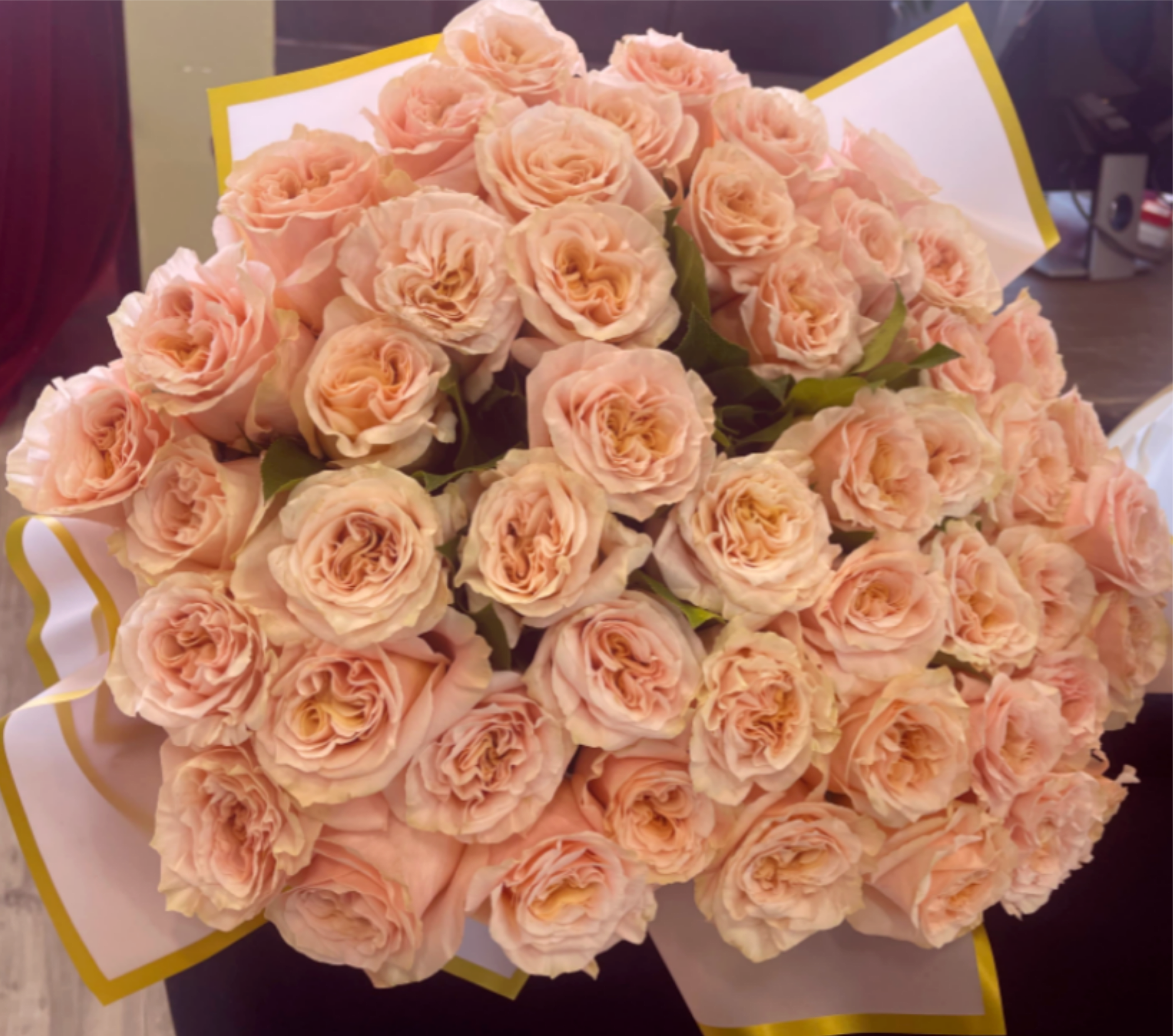 25 Peach Garden Rose Bouquet  - A classic bouquet of fresh cut garden roses, featuring a clean, elegant design perfect for any occasion.  Finished with matching ribbon. Same-day delivery available during store hours.  The bouquet does not include premium wrapping. Premium wrapping is available at an additional charge of $10. Please specify in the instructions.   Note: Exact flowers may vary slightly based on seasonal availability while maintaining overall color palette, size, and style.  Available Deluxe: 50 Roses Premium: 100 Roses   