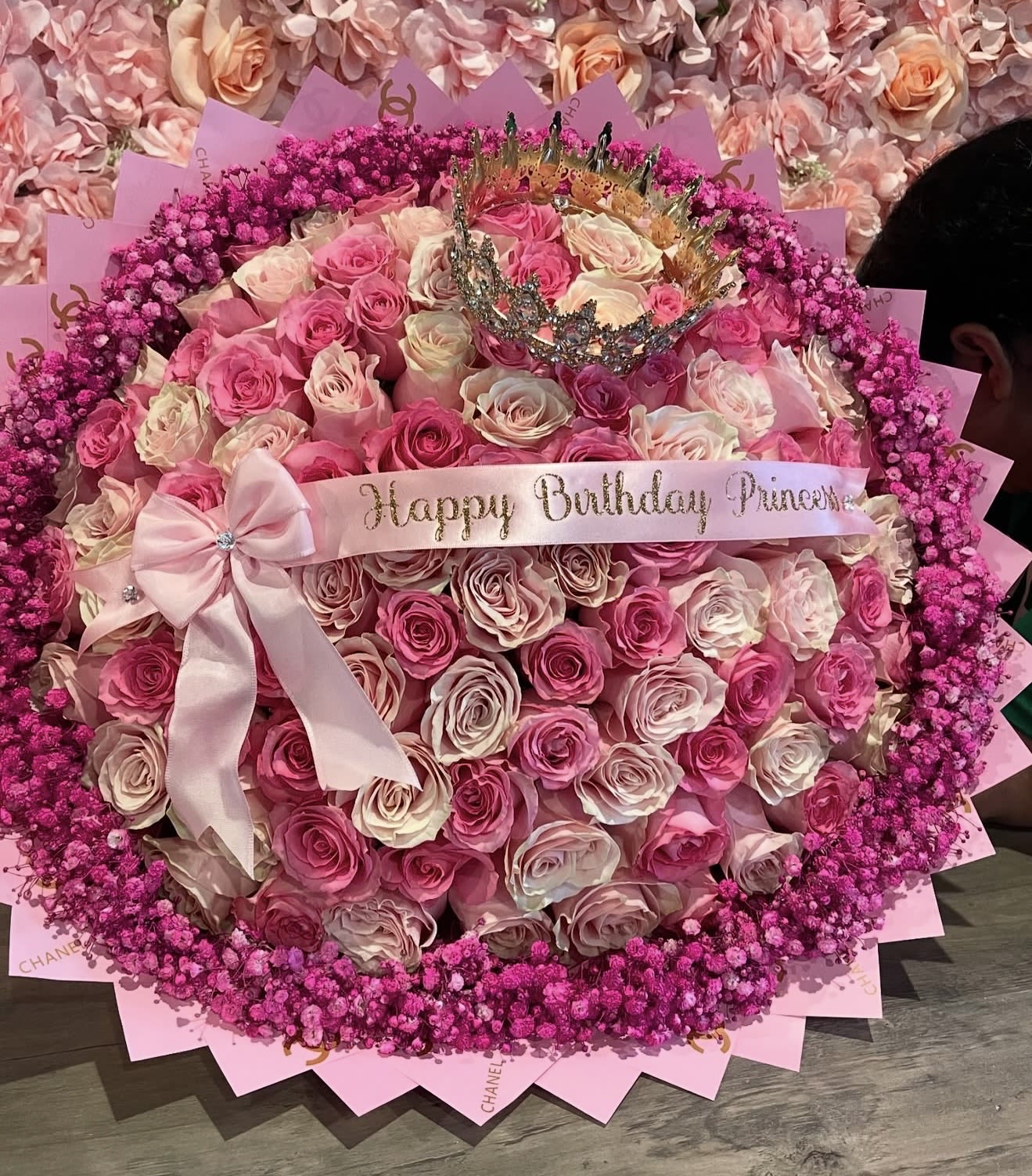 Barbie Love Bouquet  - This beautiful Megan Bouquet includes:  -100 pink roses in 2 different shades. -Hot pink baby’s breath rim. -Custom ribbon. ( wording of your choice) -Large Full Head Crown. - Pink wrapping paper.      “NOTICE”  We are dedicated to delivering your emotional sentiments with the utmost care, ensuring that each arrangement is fresh, beautiful, and arrives on time. Due to the natural variability of flowers, as well as seasonal and regional availability, substitutions may occasionally be necessary. Rest assured, any substitutions will be of equal or greater value, and we will make every effort to preserve the overall design, including the shape, size, style, and color combinations of the arrangement. In the case of single-variety arrangements, the specific variety will take precedence over color to maintain the intended look and feel. Thank you in advance for understanding that flowers are a natural product and may vary slightly in appearance.