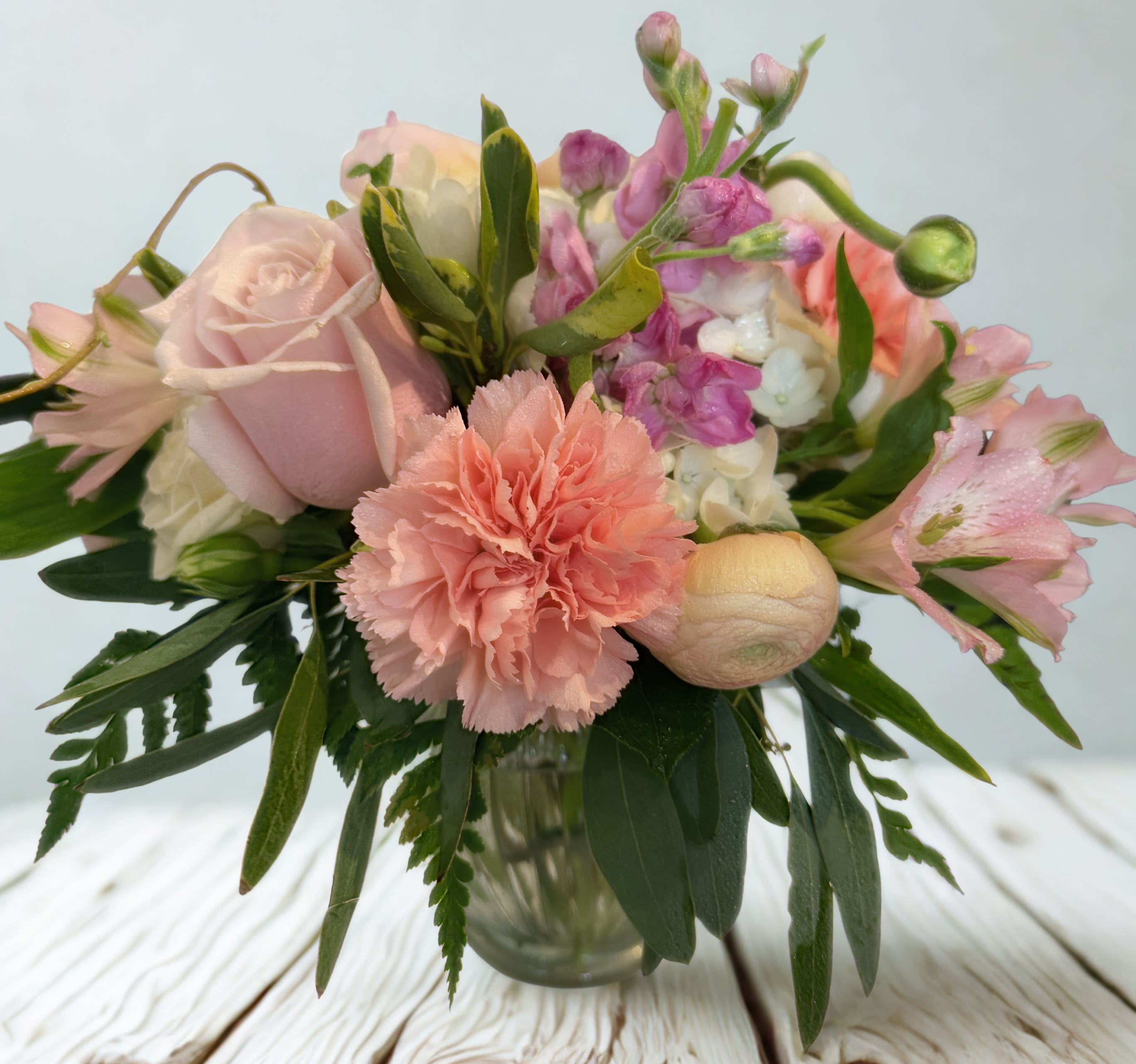 Blush Bloom Delight - Blush Bloom Delight is a romantic medley of soft pinks, peaches, and creams accented with fresh greenery for a garden-fresh feel. This bouquet blends classic elegance with playful textures, perfect for brightening a room or warming someone's heart. 