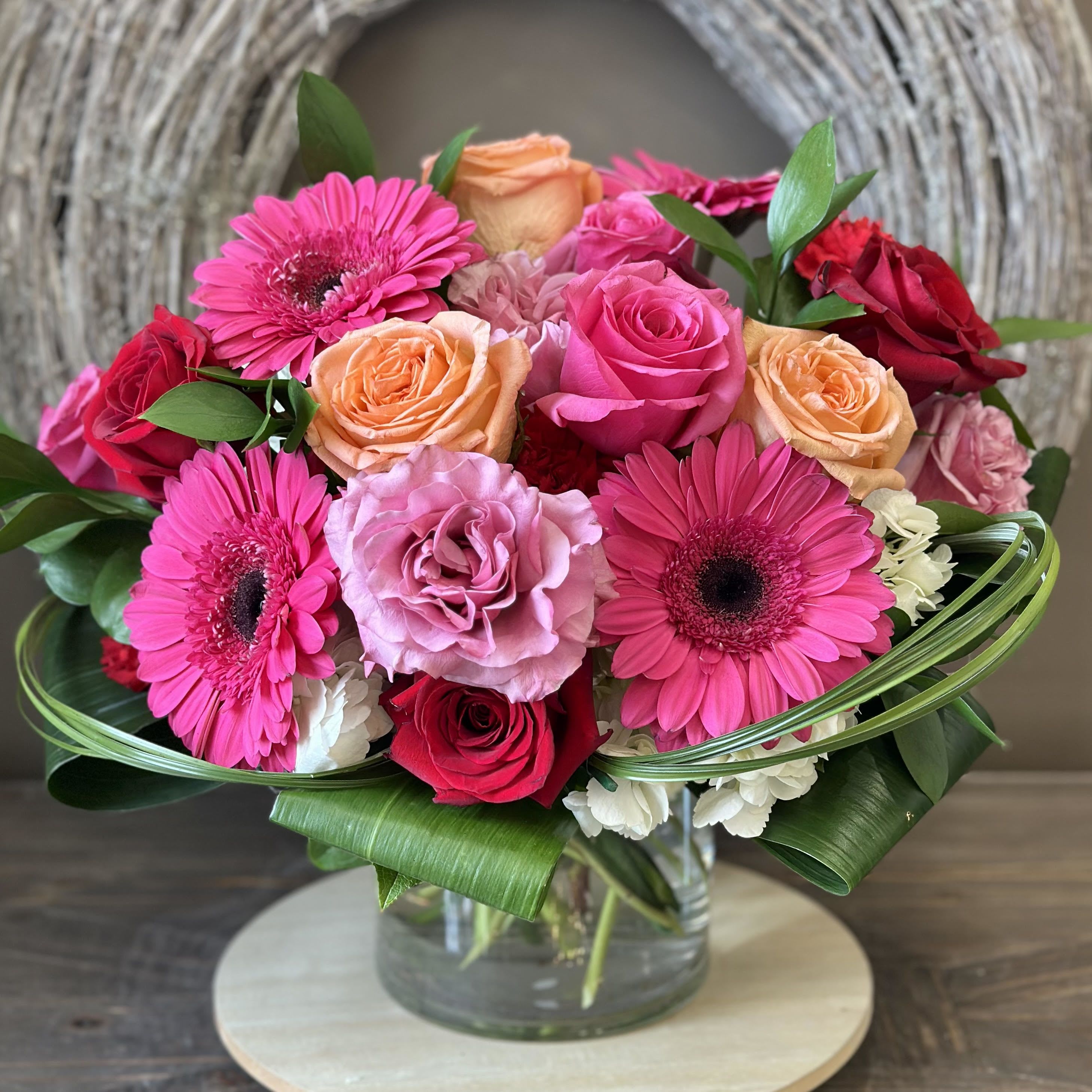 Electric Love - Celebrate love with a vibrant Valentine's Day arrangement bursting with colorful roses, hydrangea, gerbera daisies, and carnations. Designed in a clear cylinder vase, "Electric Love" is perfect for someone who loves color and a modern twist on design. Flowers &amp; colors may vary, making each bouquet a unique expression of love. LOCAL DELIVERY ONLY!