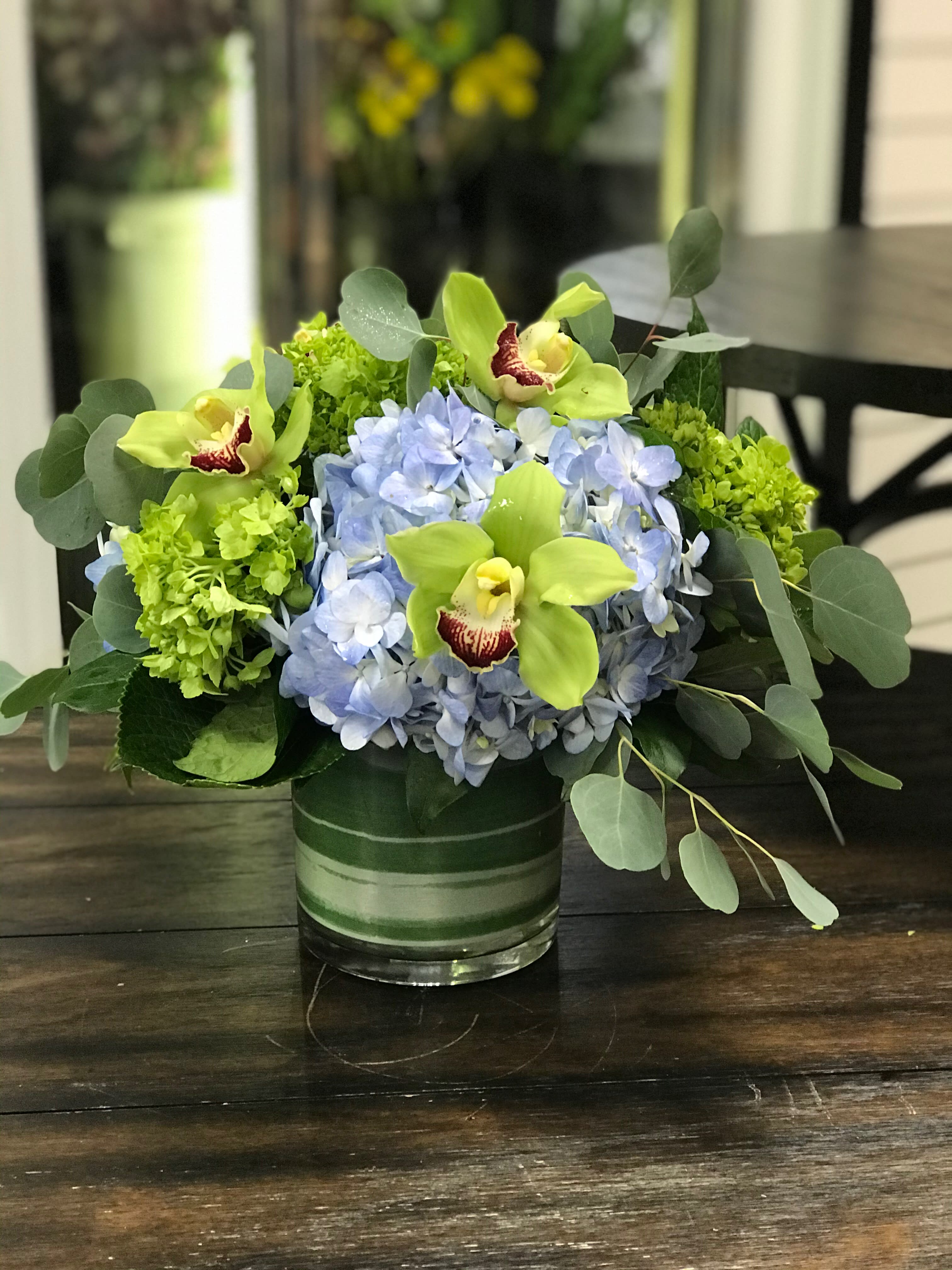 Coastal Blooms Bouquet - Arrangement includes; hydrangeas, cymbidium orchid blooms with accents of eucalyptus. Designed in a beautiful aqua keepsake glass cylinder vase. Flowers and colors may vary. LOCAL DELIVERY ONLY PLEASE!!!