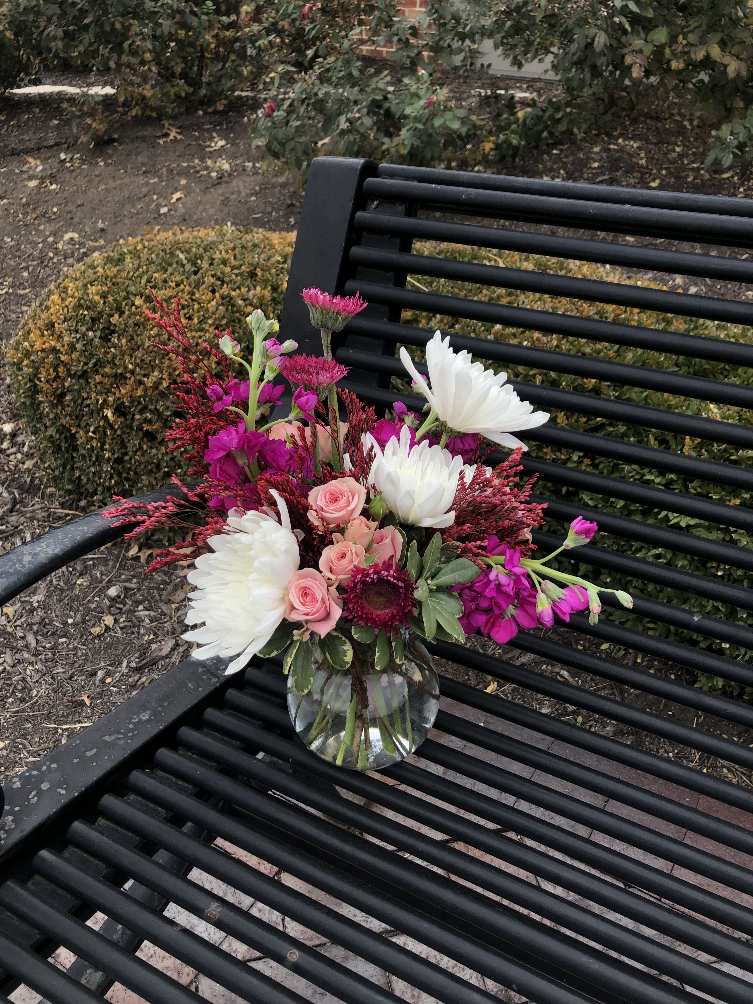 Meet Cute - This sweet arrangement is sure to brighten anyone’s day. Featuring pink, magenta, and white blooms. 