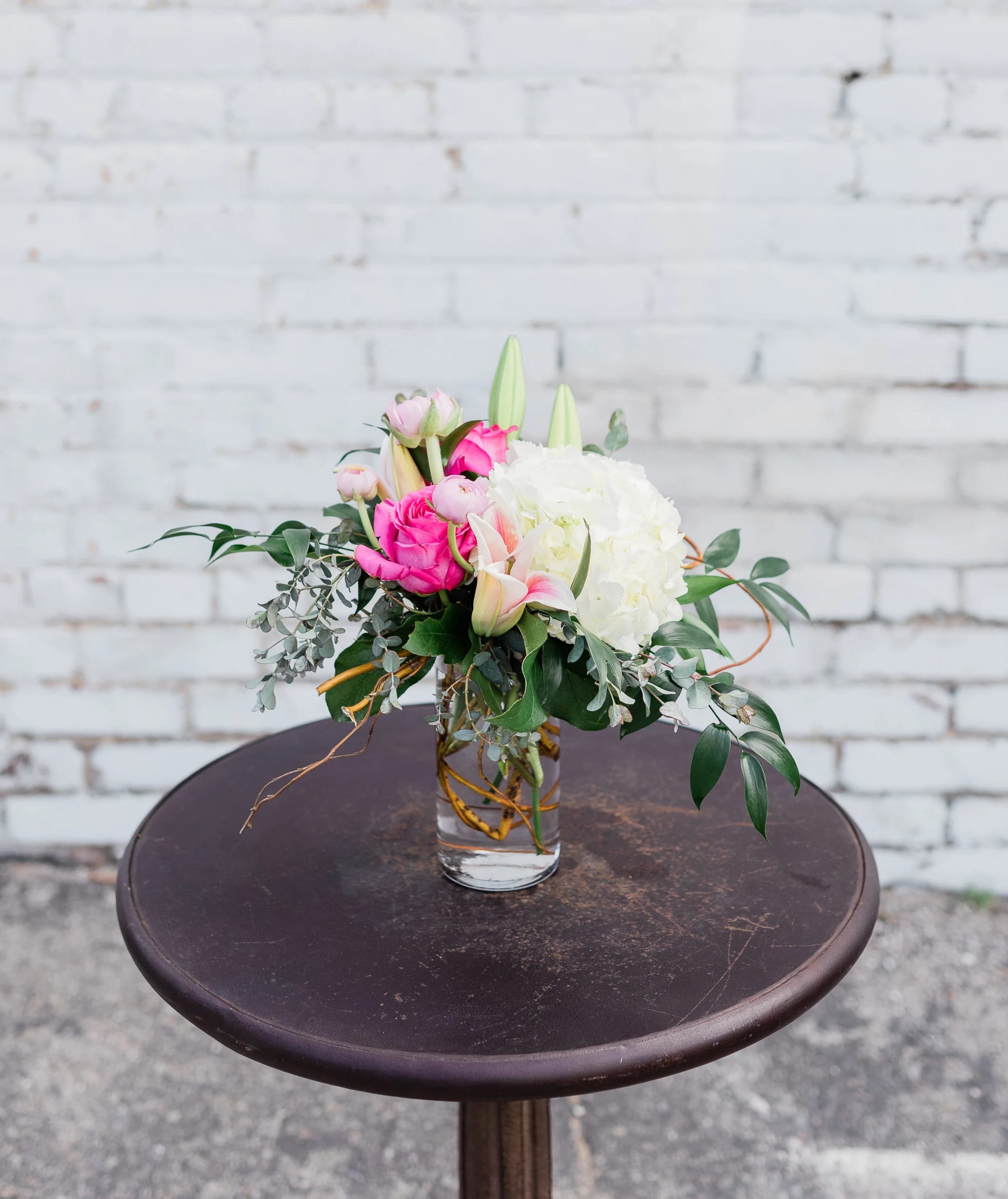 Emerald Bloom - Simple and unique mix of seasonal blooms arranged in one of our select votive vases.    pictured [DELUXE]