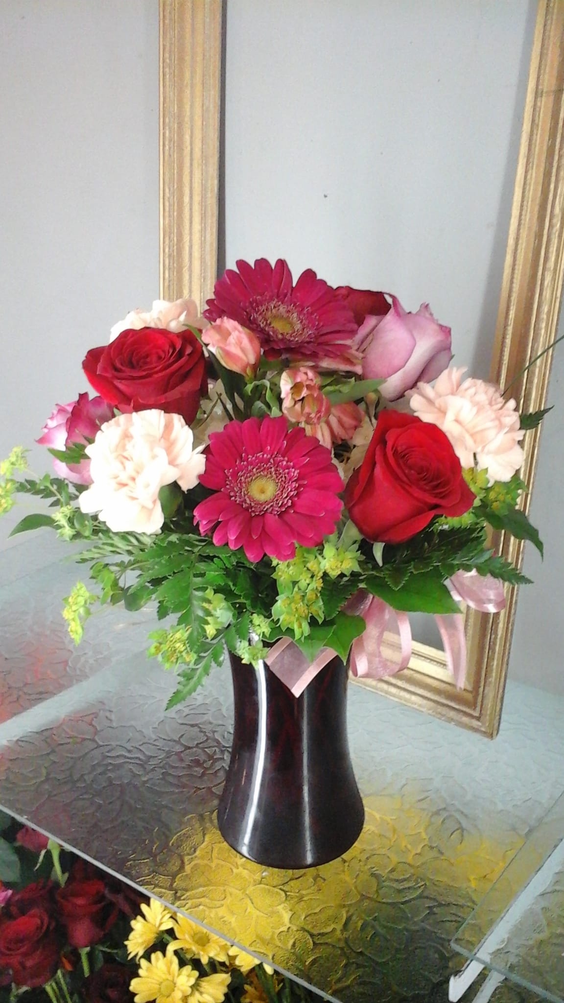 " My Girl " - Arranged in a red vase ( vase may vary   due to availability)  with hydrangea, alstomeria,  gerberas, carnations, roses and Greenery.