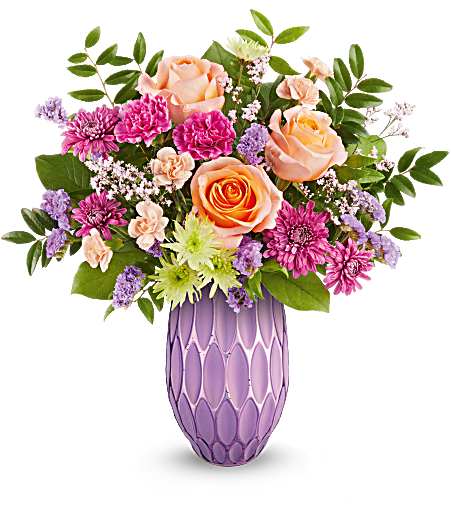 Pretty Glow - Make her Mother's Day. Shine with Teleflora's Pretty Glow Bouquet, featuring a stunning mix of roses, carnations, and chrysanthemums, beautifully presented in a sculpted glass vase with a purple mercury-inspired finish. A perfect blend of elegance and charm to brighten her special day.
