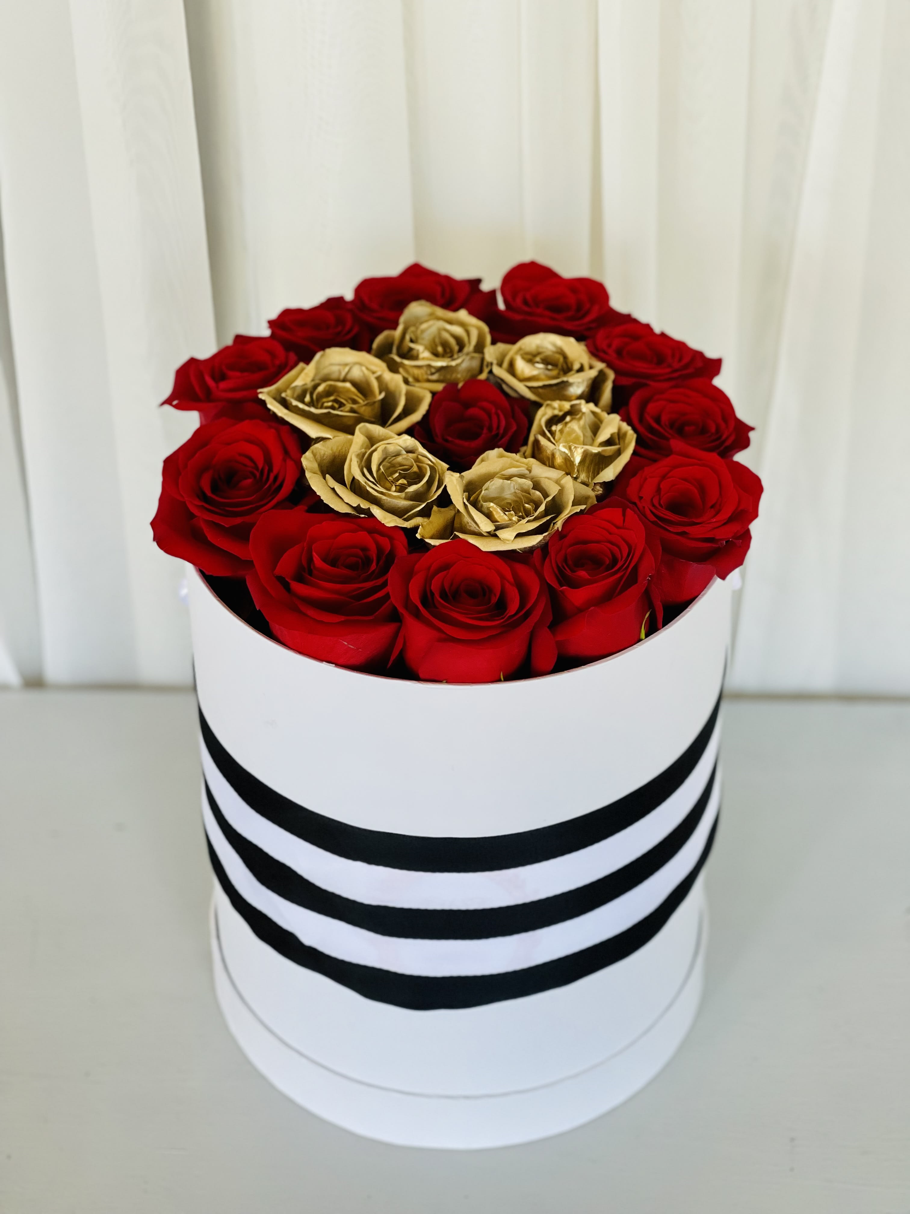 Wrapped in Red Love by Flower Carriage - Our box features red and gold roses! There’s no better gift for Valentine’s Day, a birthday, an anniversary, or just because. It looks perfect in the bedroom or displayed on your coffee table.  Approx. dimensions: W: 8 1/2 H: 10 1/2 Around  *Customize to any color roses  (If you would like to change rose color please leave it in the notes or call us, if not it will be ordered as pictured)