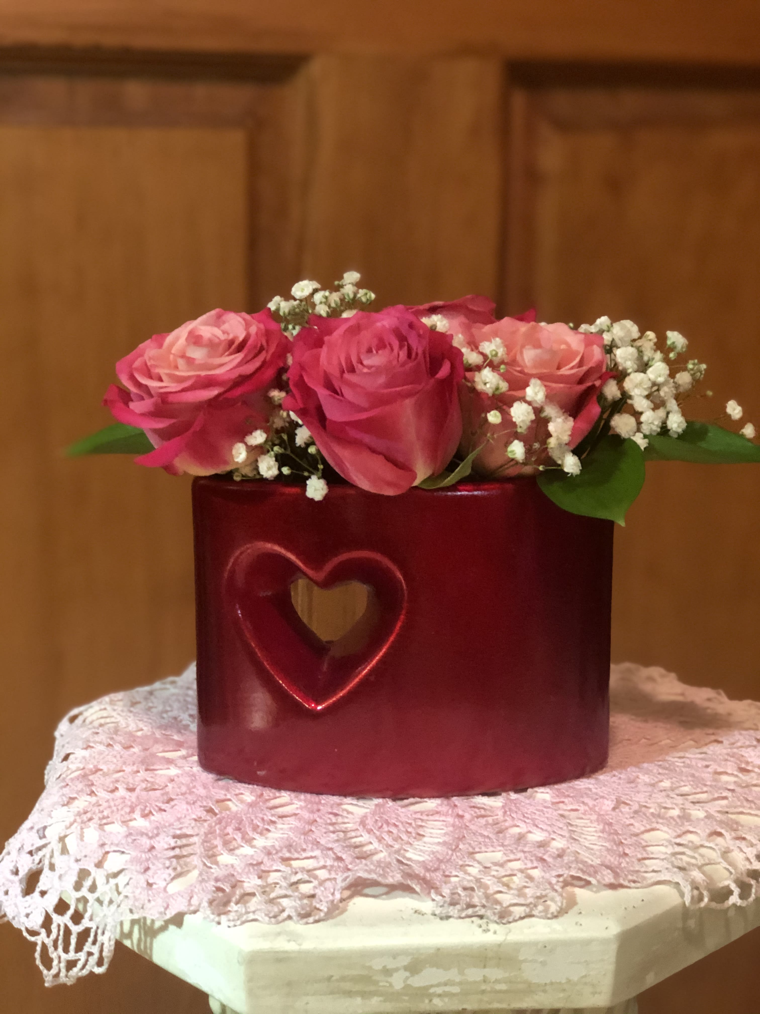 Love Joy - Just when you are in the mood for romance, a touch of whimsy, or just a playful state of mind. Love Joy is sure to fit the bill.  A playful mix of 4 premium roses, baby's breath and greenery nestled into a rectangular container with a cut out heart. Dimensions: 4 1/2" tall X 5 1/2" wide.