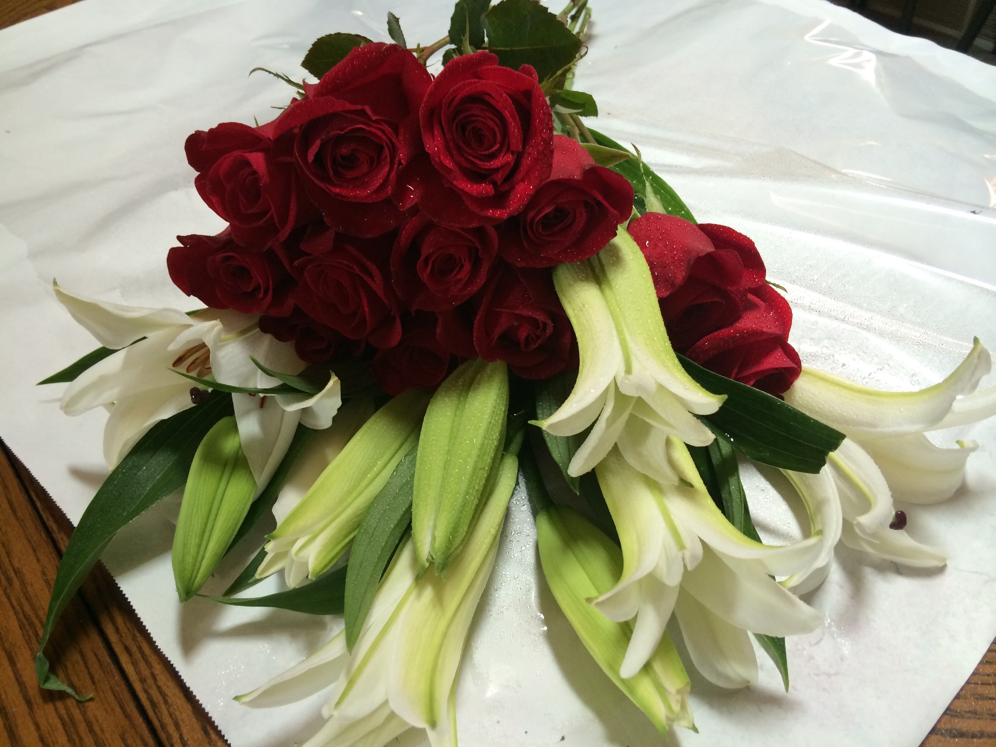 Imperial Red &amp; White Pairing - A dozen premium red roses combined with white lilies custom wrapped to create a wonderful contrast in your own cherished vase. (vase not included)