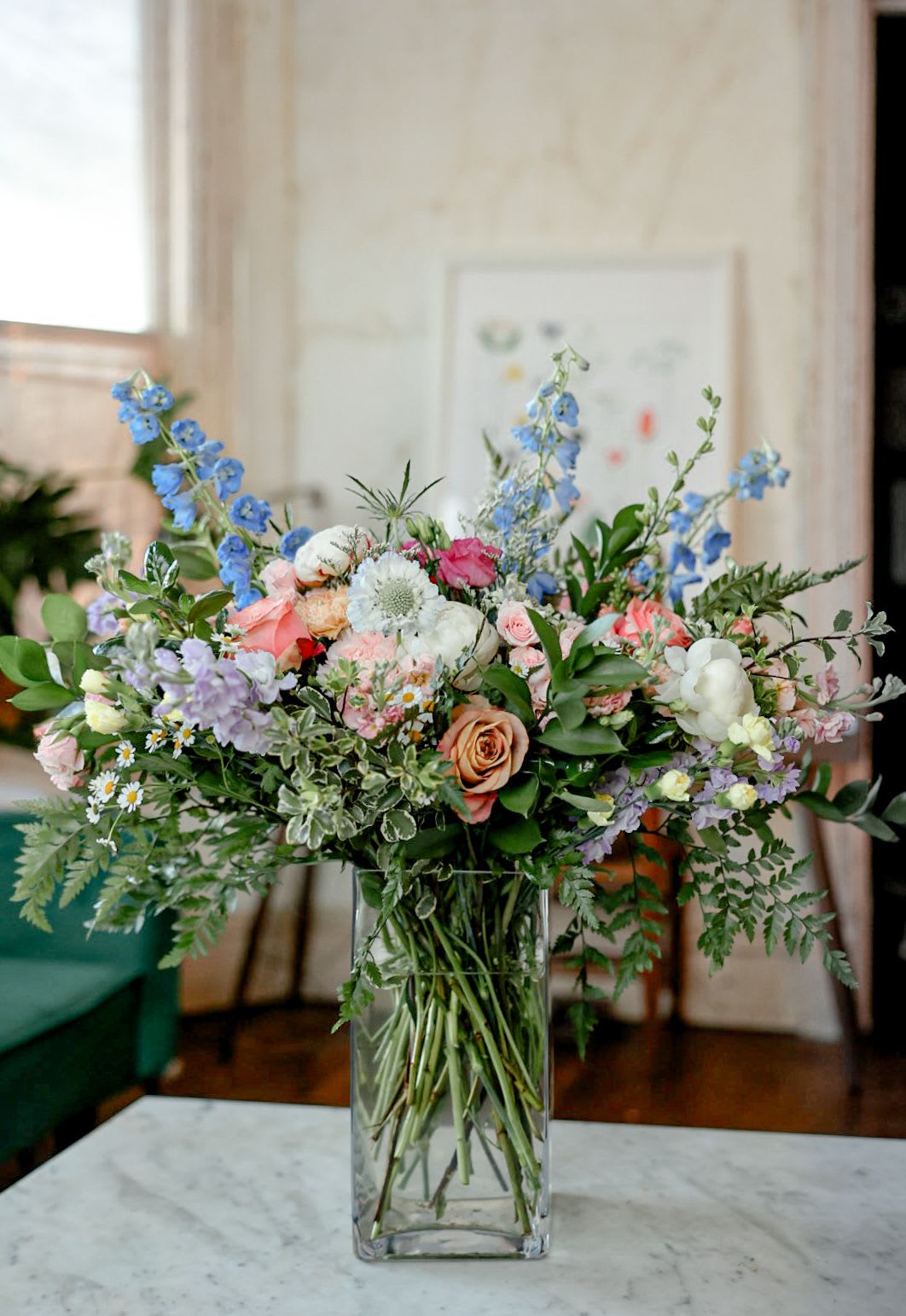 Cottage Elegance - A truly lovely arrangement of roses, delphinium, stock, wildflowers and greens. 