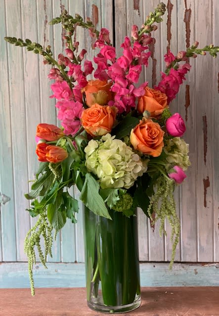 Tall Spring Mix - Tall ti leaf lined vase filled with lush green hydrangea, viburnum, tangerine roses, pink snapdragons, orange parrot tulips &amp; hanging green amaranthus. Due to covid related shortages we may not be able to match the arrangement exactly.  Containers or flowers may substituted at designers discretion. Thank you for your understanding.