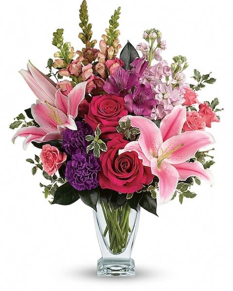 Teleflora's Morning Meadow Bouquet - Hand-delivered in a shapely glass vase, this sumptuous arrangement of roses and lilies is a lavish way to celebrate a special day - or surprise someone just because! Hot pink roses, pink spray roses, pink oriental lilies, purple alstroemeria, purple carnations, light pink stock and pink snapdragons are arranged with pitta negra and camellia leaves. Delivered in a clear Couture vase.   Orientation : All-Around  All prices in USD ($)  Due to an increase in the cost of roses, some product prices may be impacted during the Valentine’s delivery period.